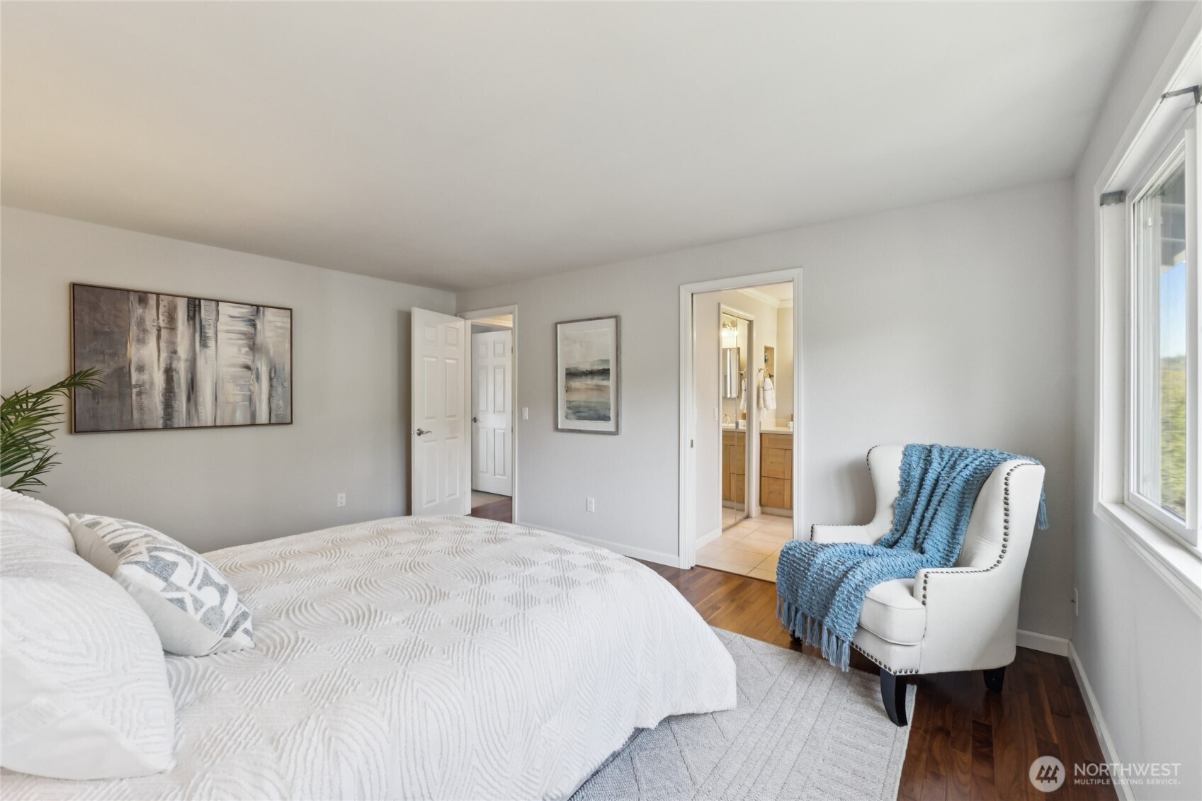 A second view of the primary bedroom highlights its generous scale, with a seamless connection to the ensuite bath.
