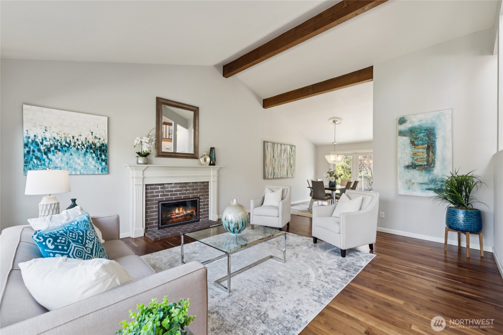 The vaulted ceilings and warm wood beams draw your eye up, while the fireplace creates a natural place to gather and settle in.