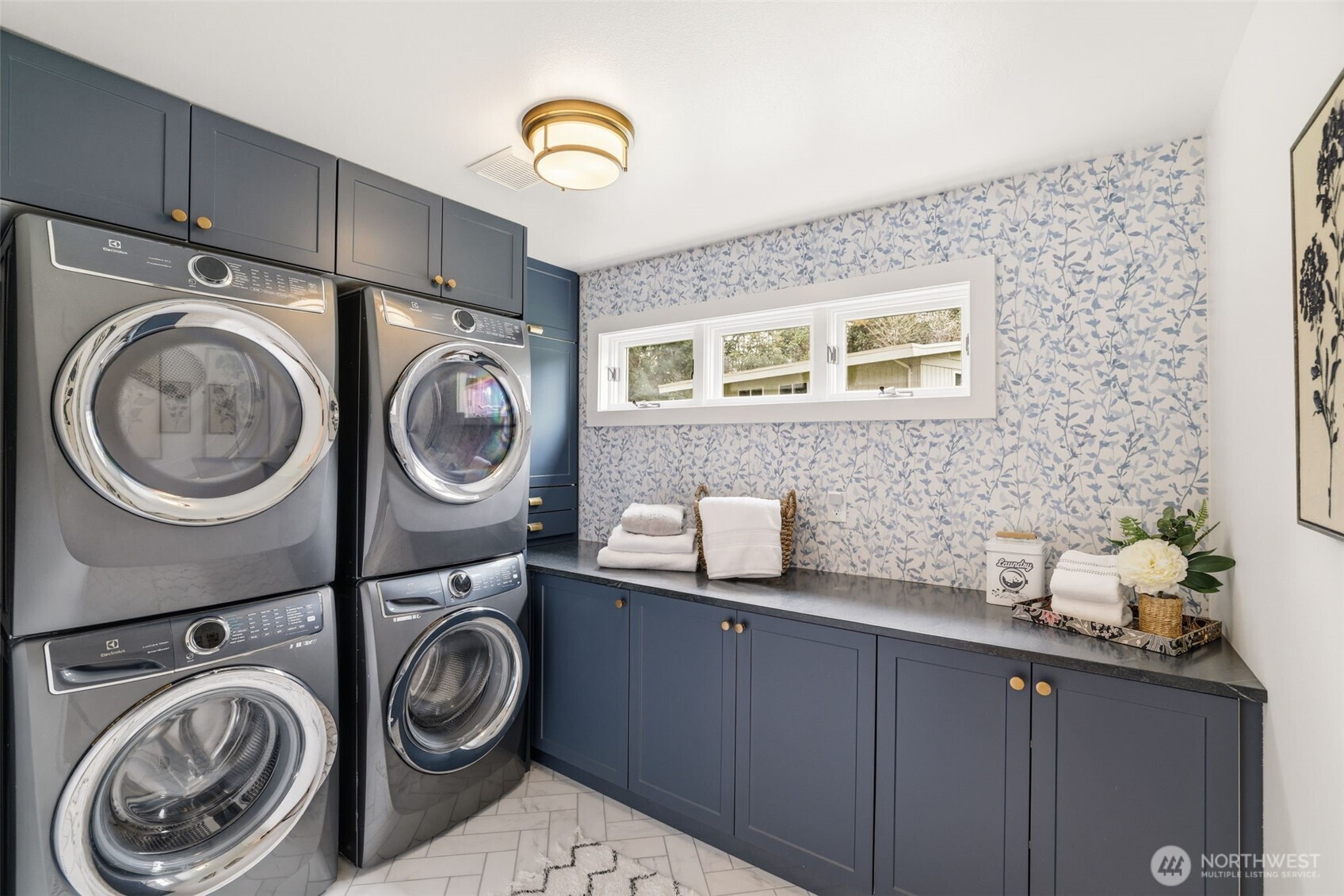 Well-designed laundry room with dual washer and dryer setup