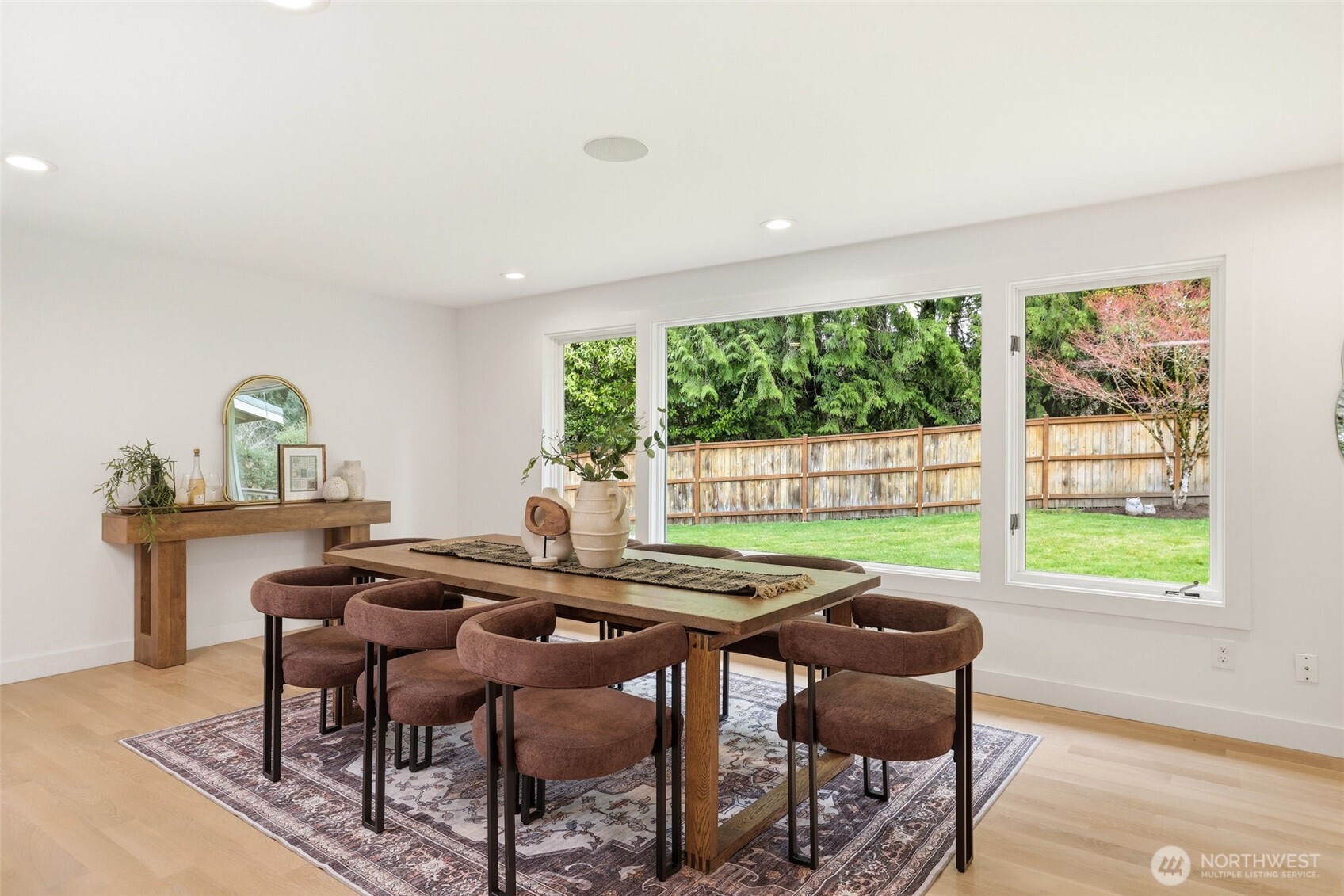 Dining area overlooking private backyard and greenery