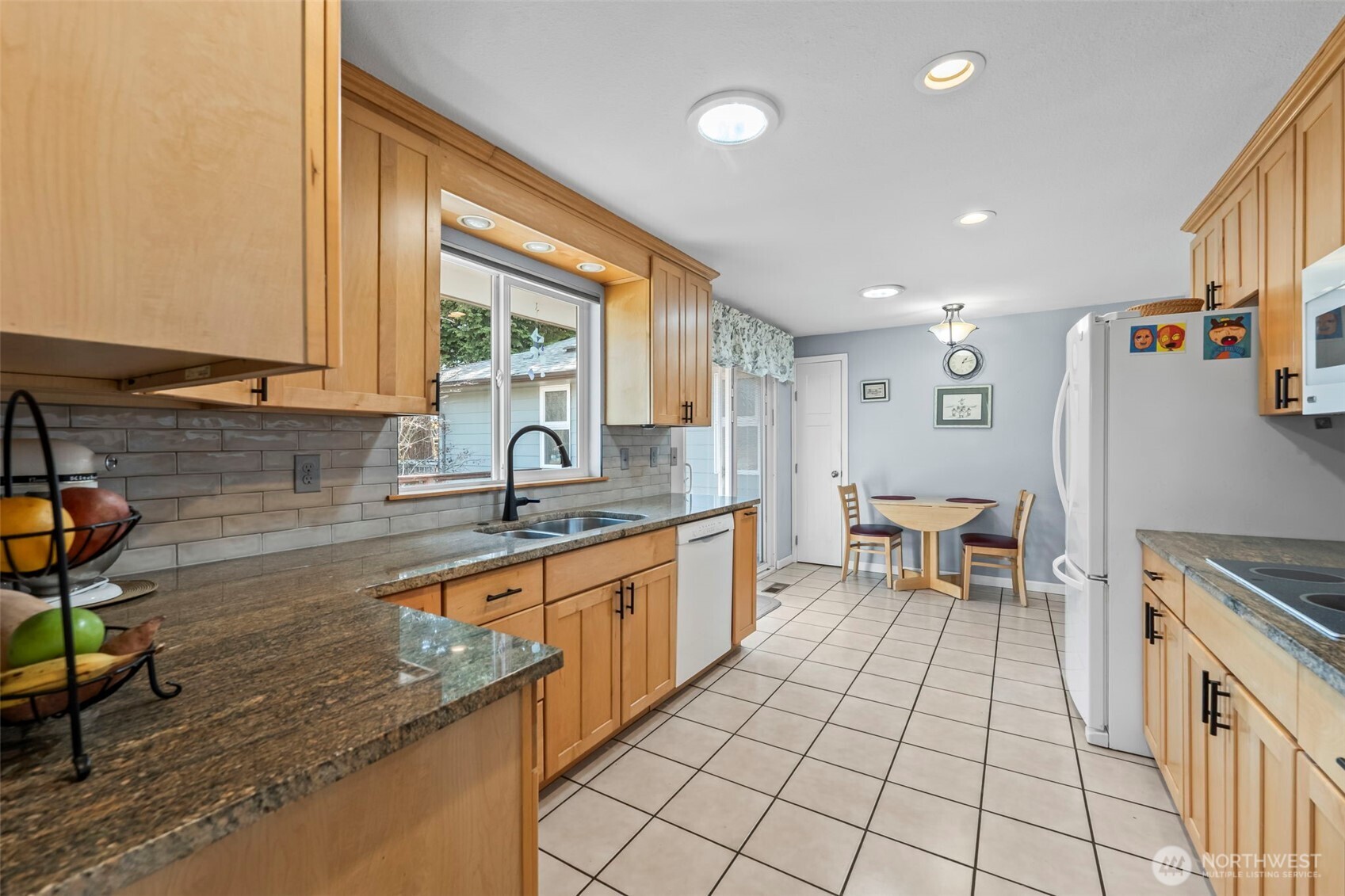 Kitchen with updates like maple cabinets, granit counters and tile floors