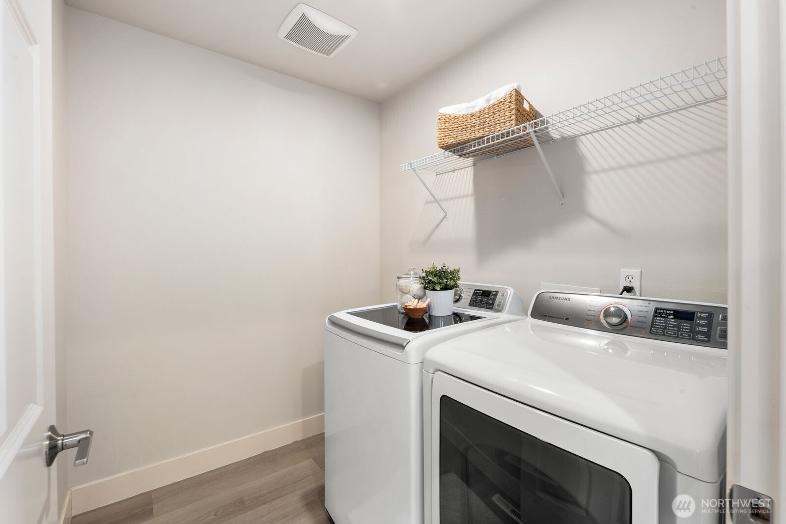 Laundry room, complete with full-size washer/dryer set.