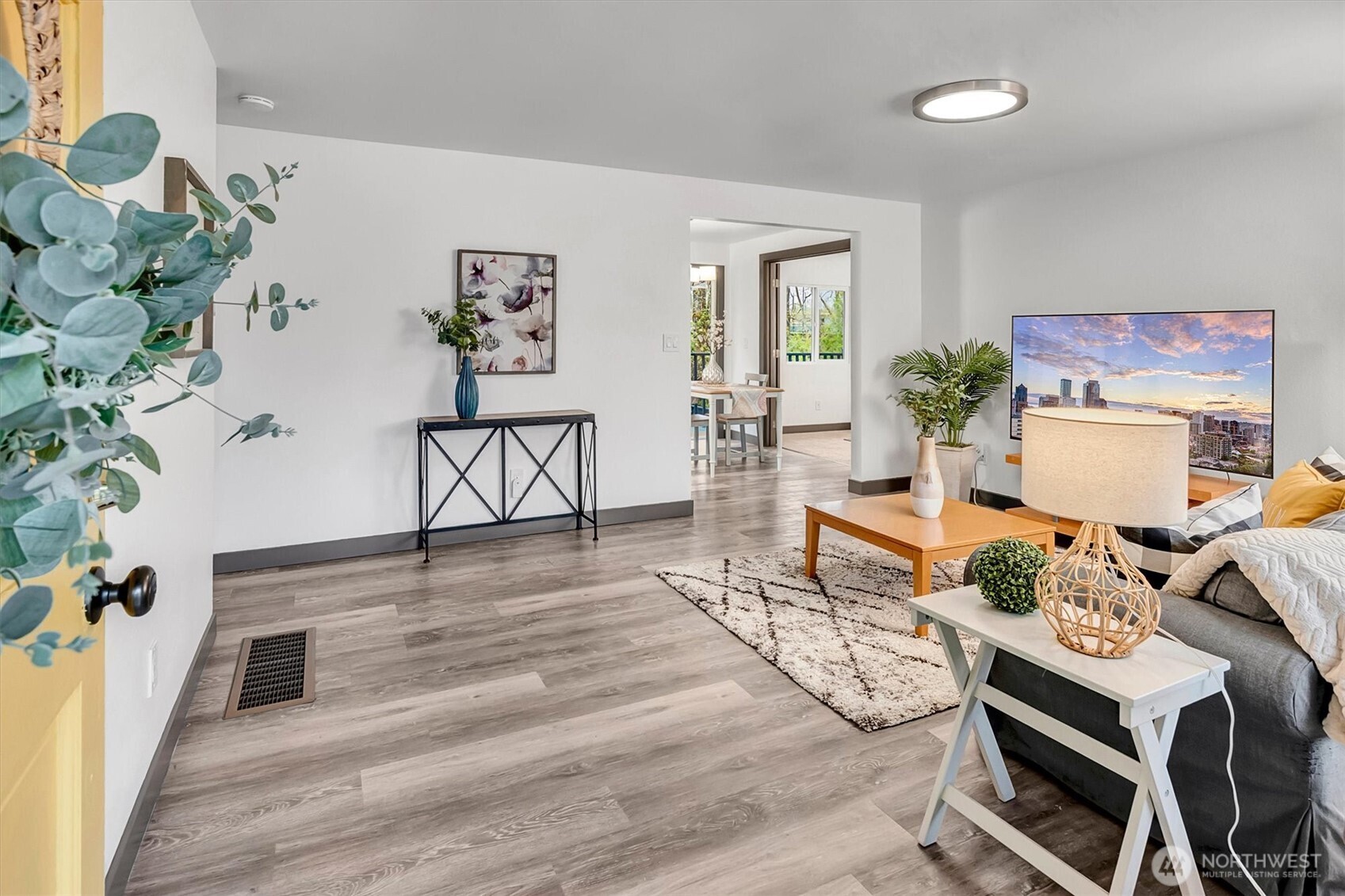 Step inside to discover a thoughtfully refreshed interior featuring fresh paint and stylish flooring, creating a bright and inviting atmosphere.
