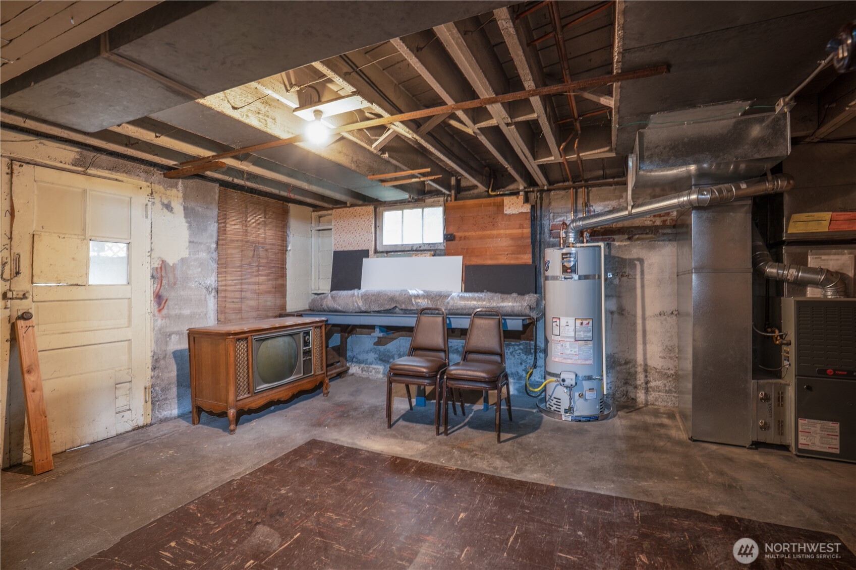 The hot water tank and furnace are much newer than the home (whew.)  Enclose them and you still have another huge finishable room with egress.  Could be an a.d.u. or just extra living space.