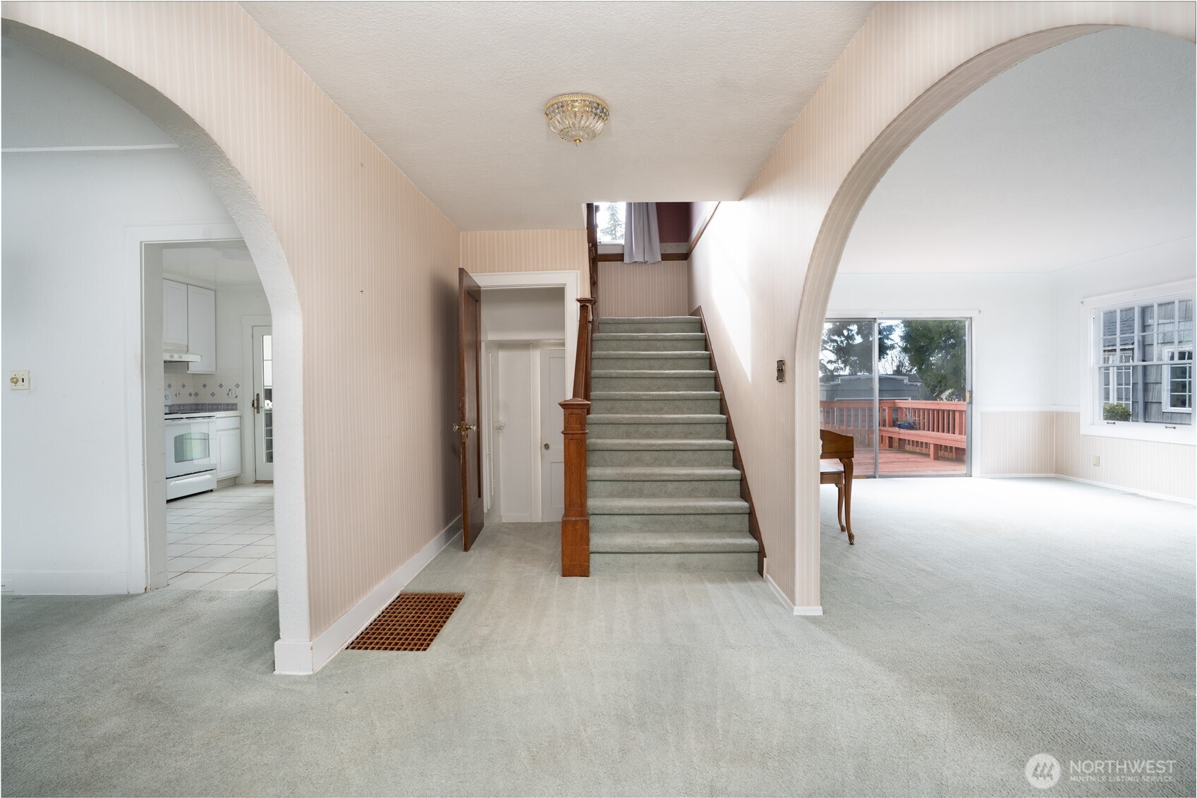 Welcome.  To the right is the large living room, to the left is the dining room and kitchen, to the left of the staircase is a half bath and the stairs to the unfinished basement.