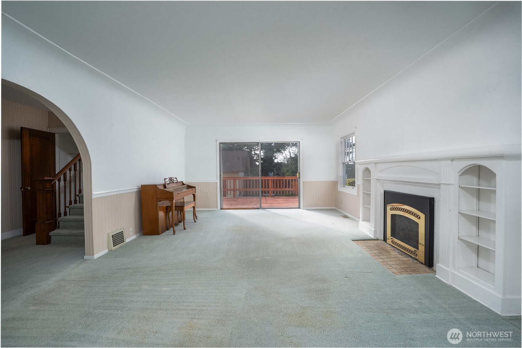 The living room is ginormous and is complete with a gas fireplace flanked by built-ins.  Access to the large deck and back yard make for easy indoor/outdoor living and lifestyle.