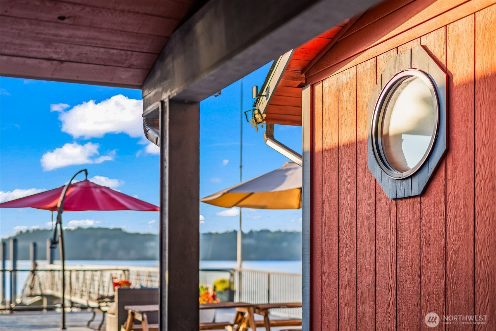 Picture windows bring the outdoors in, showcasing sunsets and Sound views.