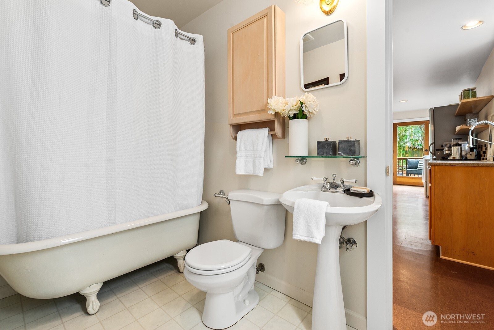 Full bathroom on the main floor between the kitchen and bedroom.