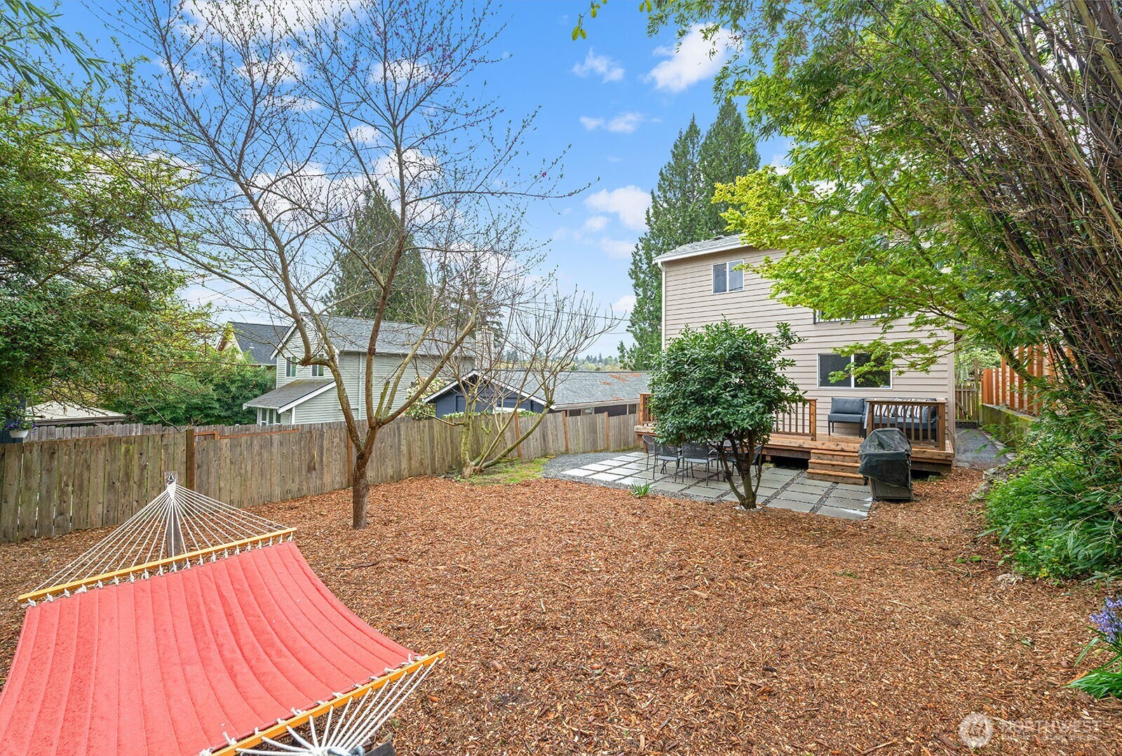 Spacious rear yard allows for play space, gardening, or relaxing in the hammock.
