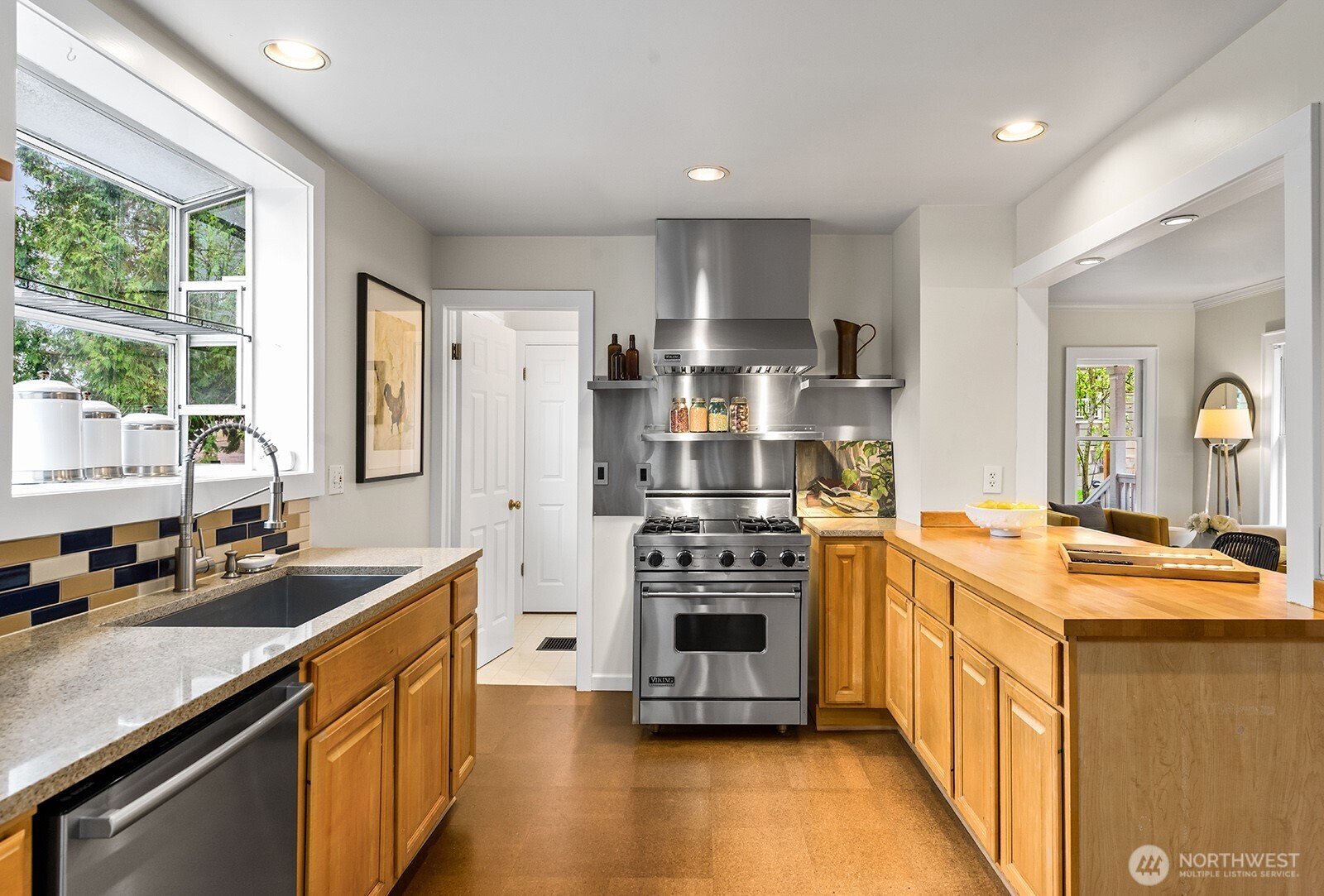 Kitchen with a commercial style Viking stove/oven, hardwood counter, and cork floors.