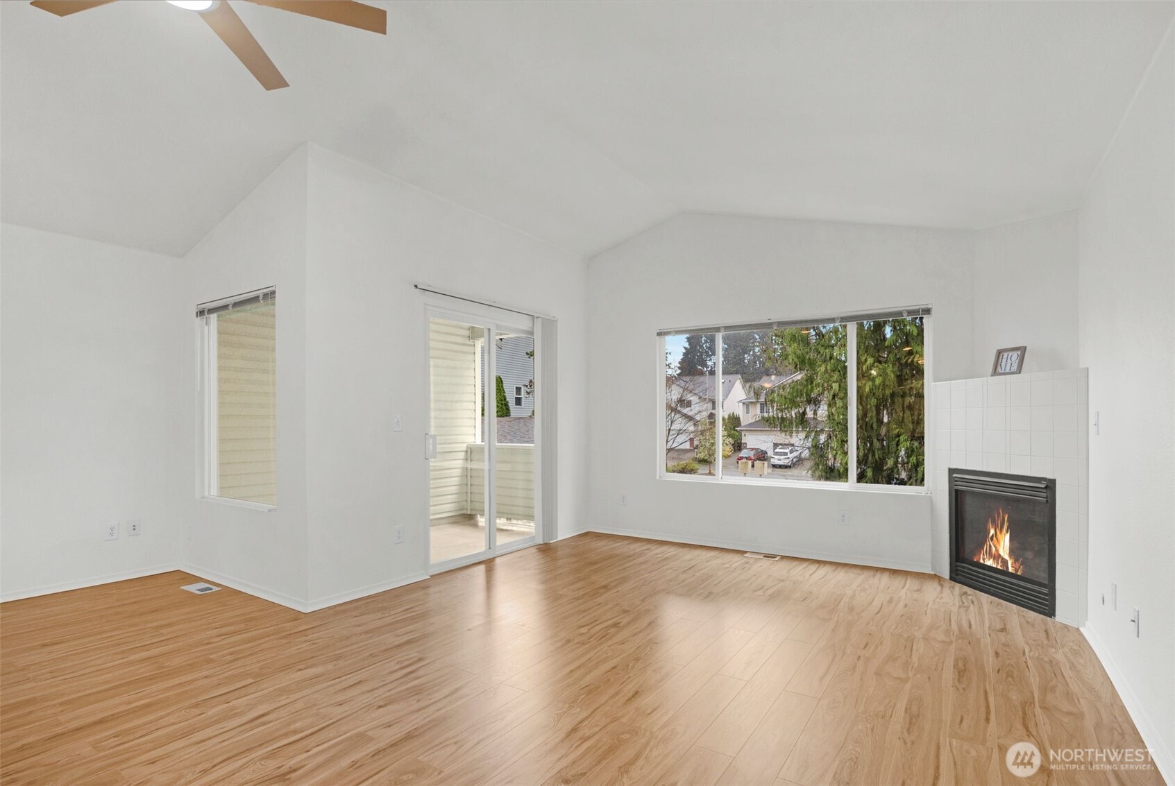 Expansive living room with gas fireplace and slider to a cover deck