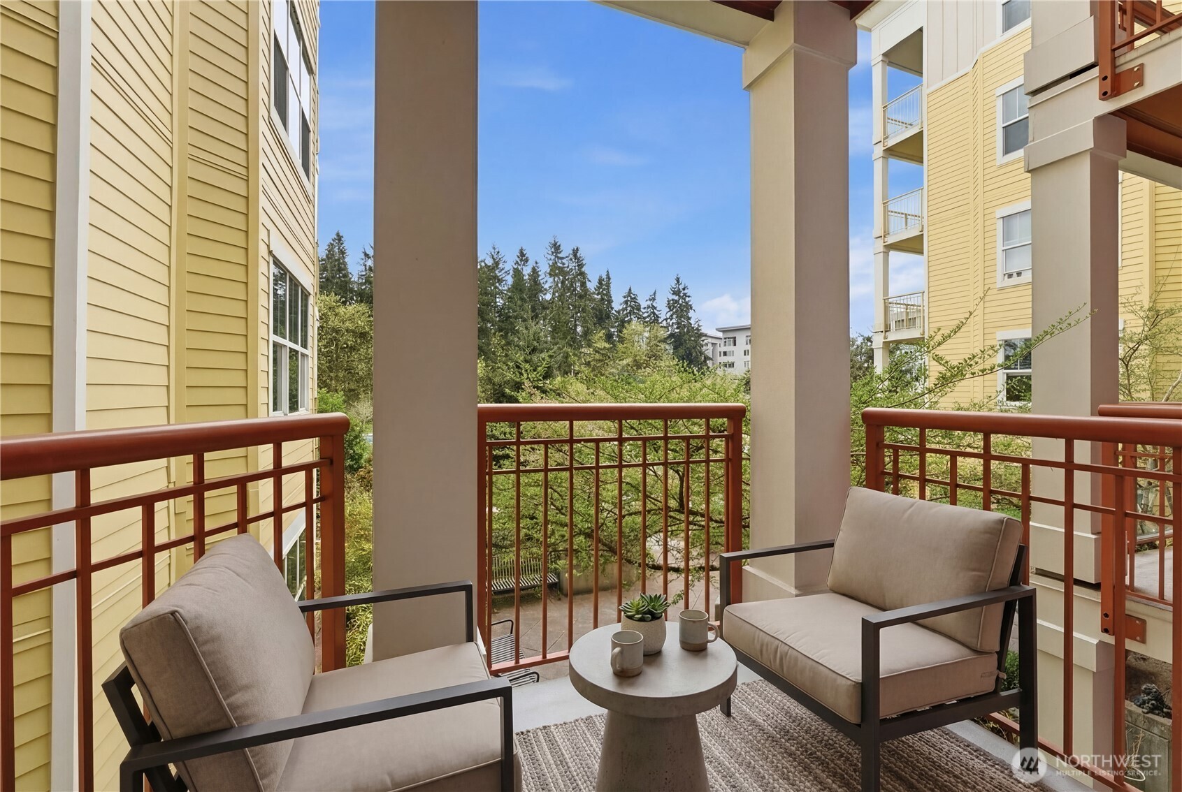 Inviting, virtually staged balcony — a cozy spot for morning coffee or evening unwinding with views of the park and trail