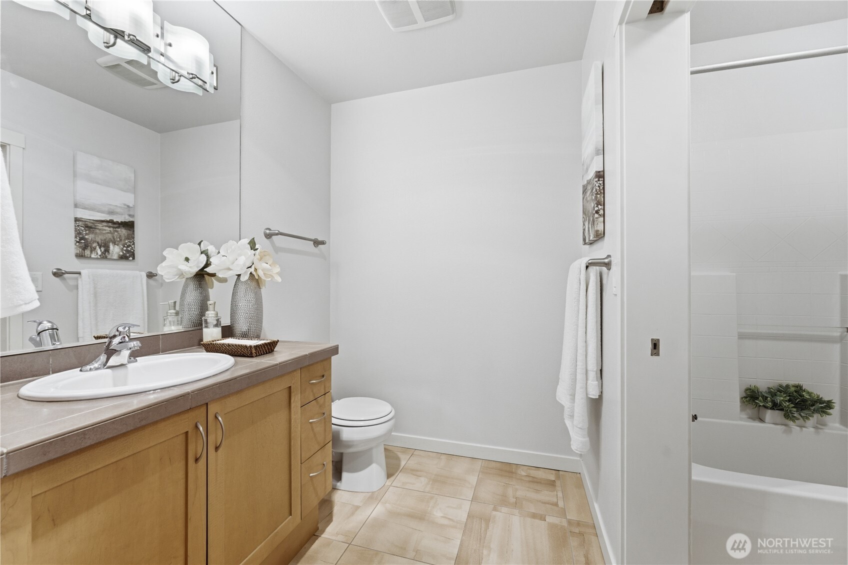 Bathroom with convenient dual entry — accessible from both the bedroom and the main living area for easy guest use