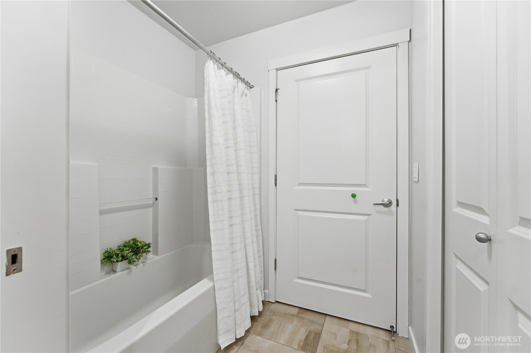 Bright shower-and-tub area with fresh, neutral finishes and a clean, modern look