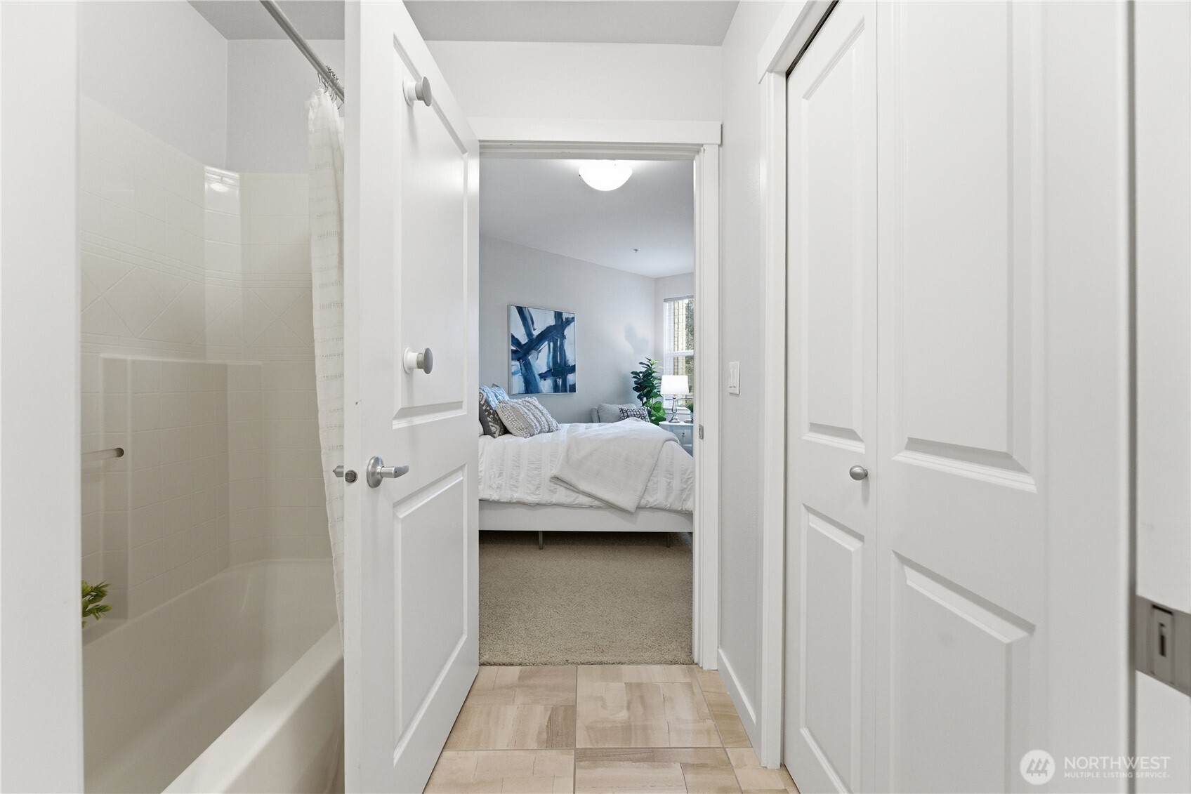 Bright hallway connecting the bathroom, storage, and the bedroom - an easy, intuitive layout