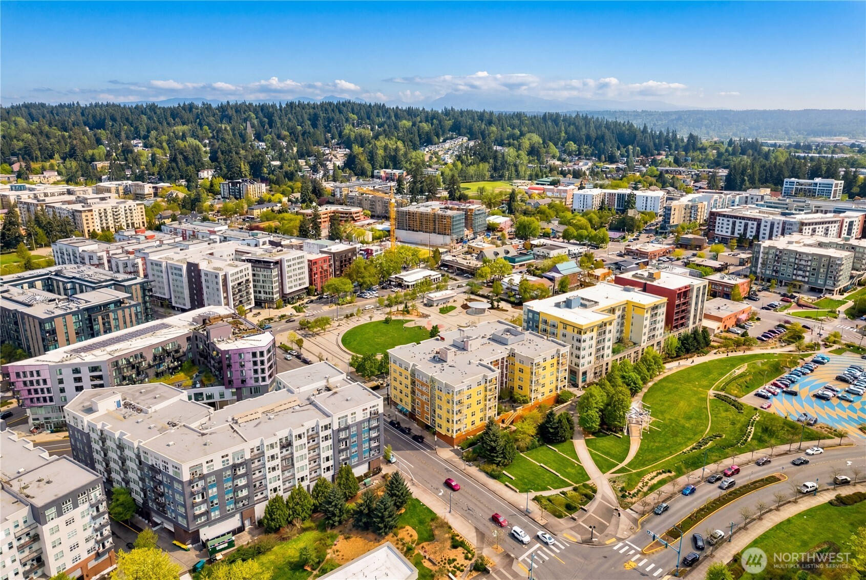 Aerial view of the surrounding community, showcasing nearby buildings, green spaces, and well-planned neighborhood layout