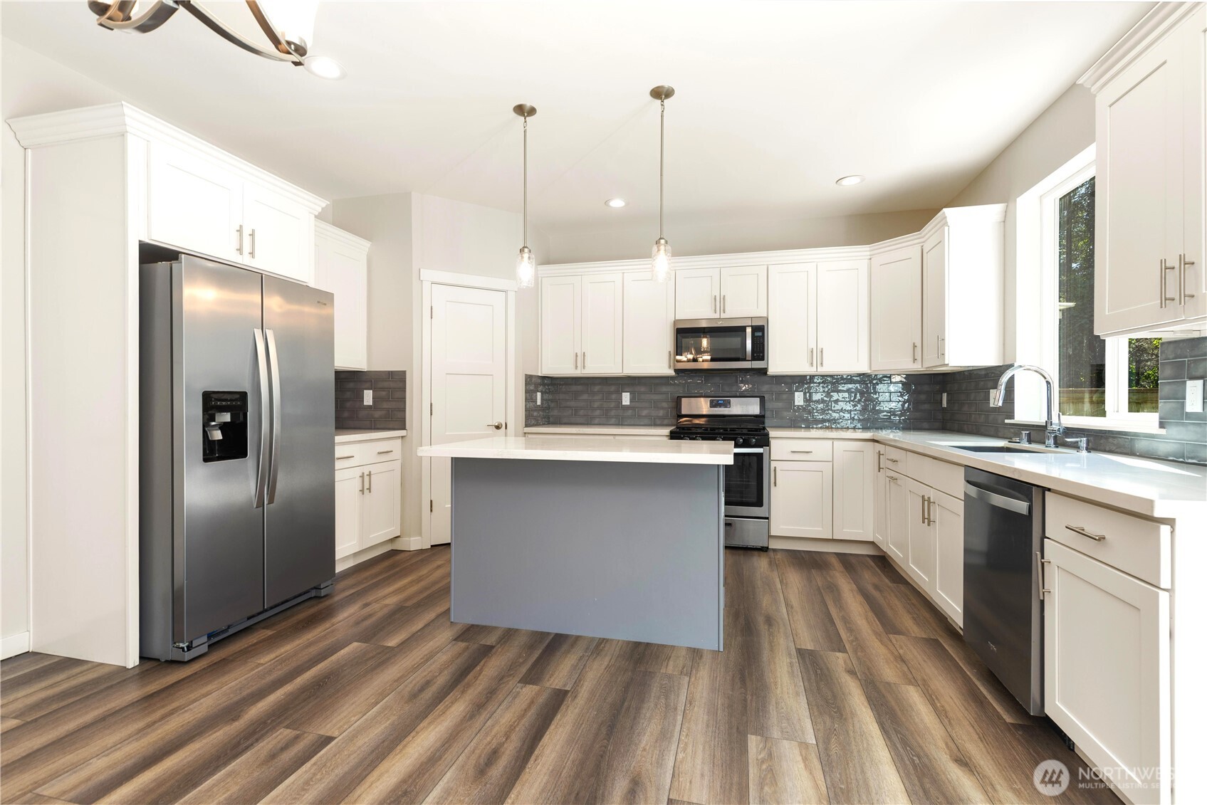 Gas range -Room for  casual eating spaces on Island. Quartz countertops, all stainless appliances.