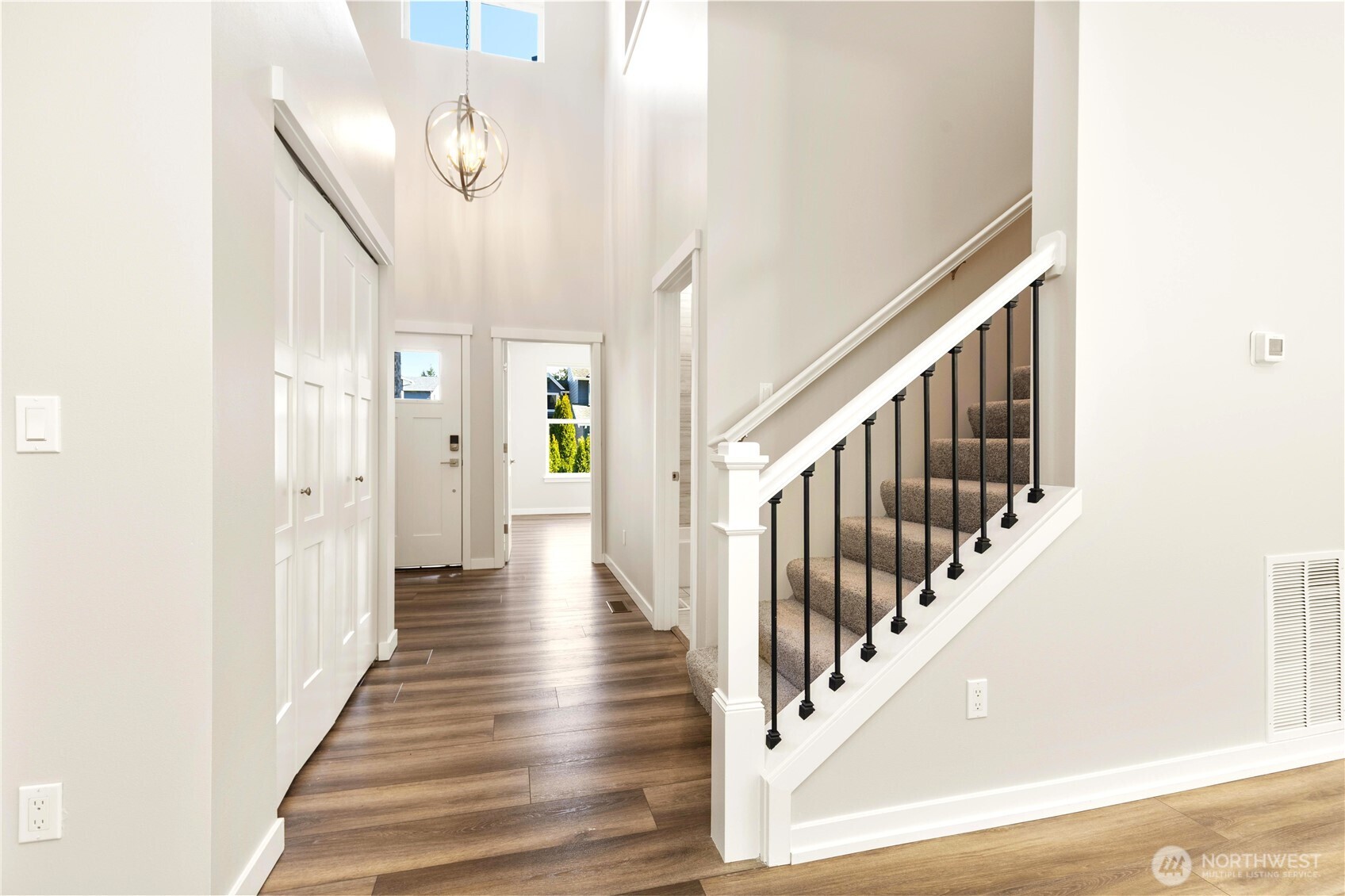 Generous transition space with large Coat closet separating entry from main rooms