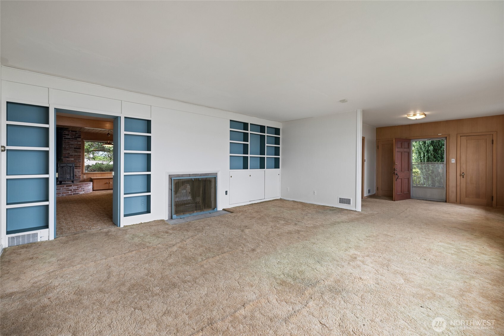 Cozy fireplace and the side door leading to the backyard