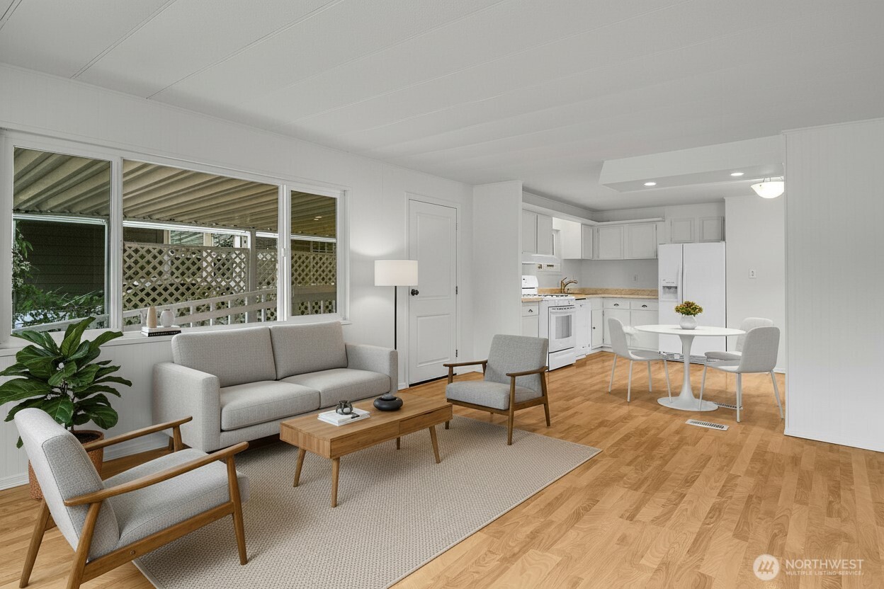 Looking back towards the cheery and bright kitchen, the living room is spacious enough for a variety of furniture configurations. *Virtually staged