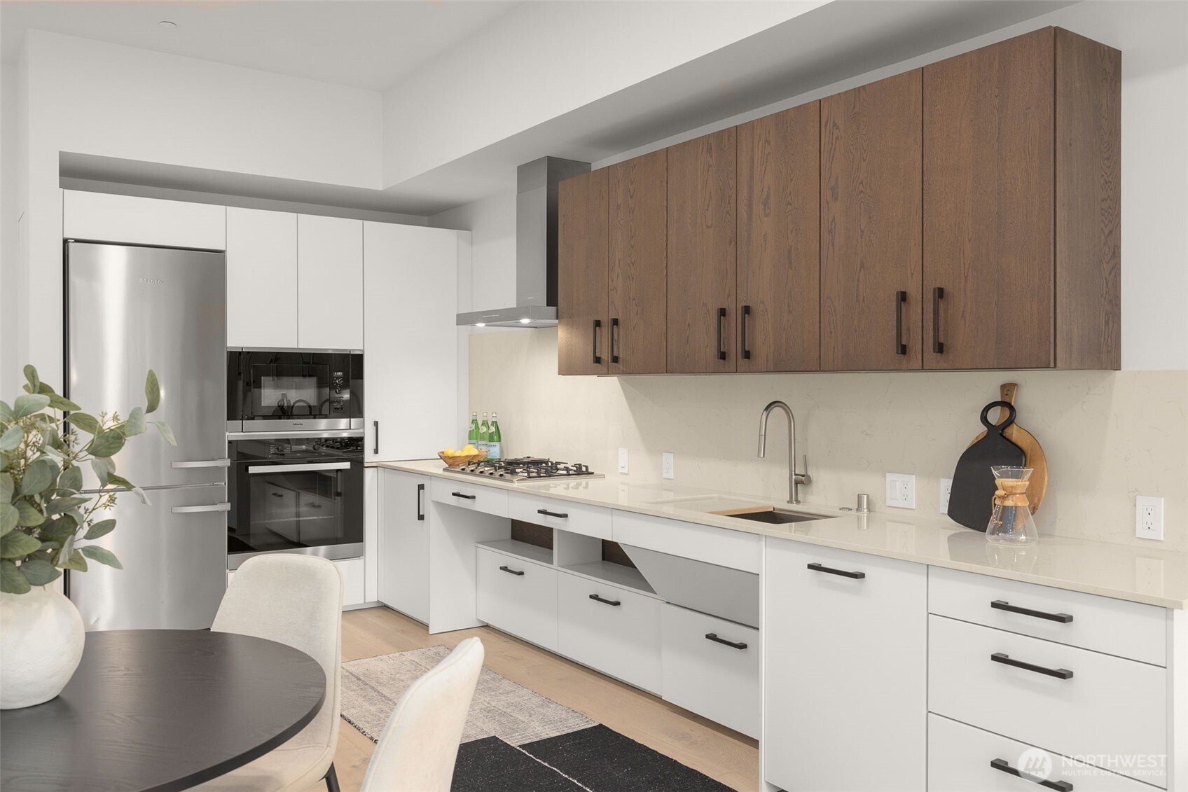 Miele appliances, quartz countertops, gas range and ADA Custom Cabinetry