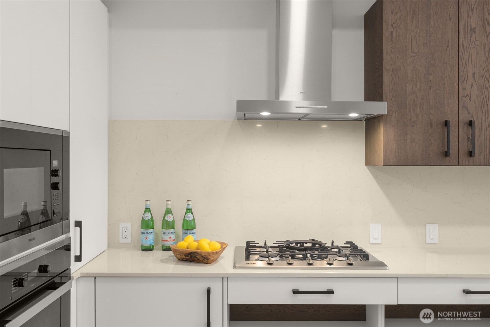 Miele appliances, quartz countertops, gas range and ADA Custom Cabinetry