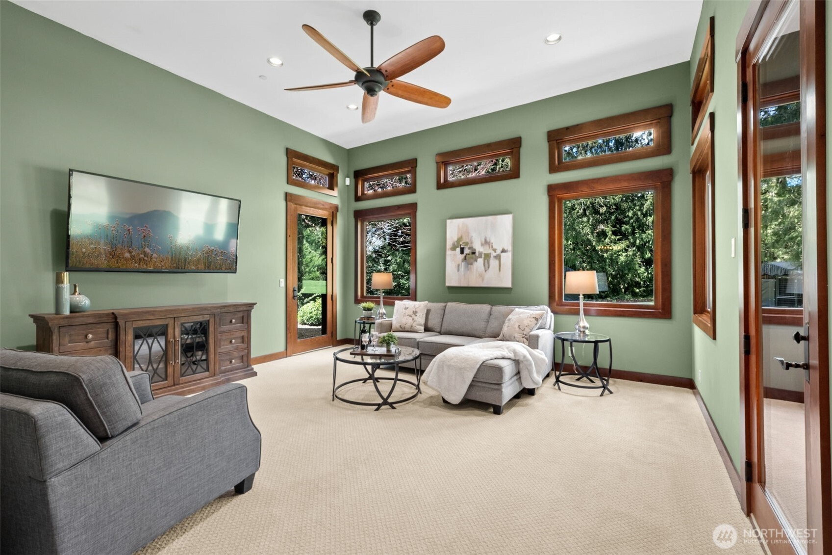 Designed for everyday comfort, the back family room offers a bright, welcoming setting with easy access to the covered outdoor living area—perfect for indoor-outdoor living in every season. -- The architectural details do not stop here, however -- the gorgeous wood-wrapped windows, including several clerestory, and the wood fan highlights the detail at every turn in this gorgeous home.