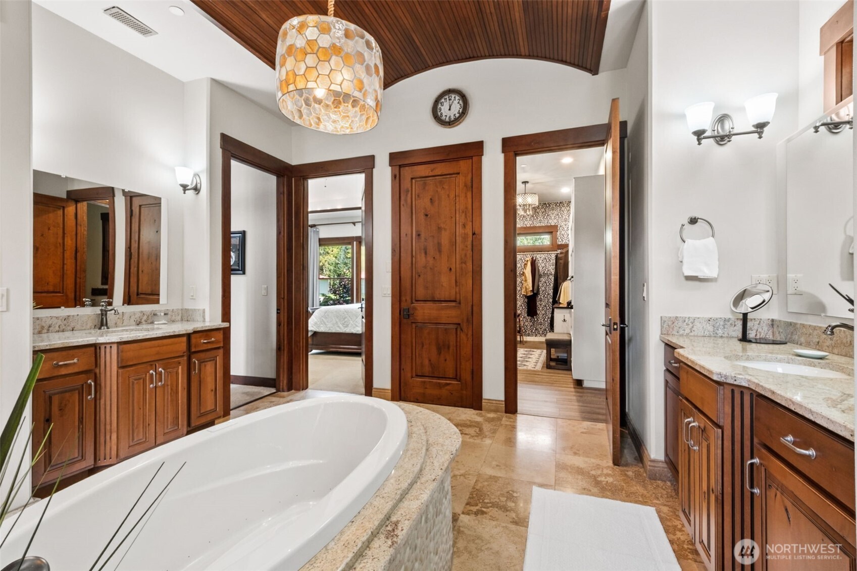 Every detail is designed for comfort and style—from the dual vanities and relaxing soaking tub to the warm finishes and distinctive designer light fixture that brings a soft, inviting ambiance to the space.
