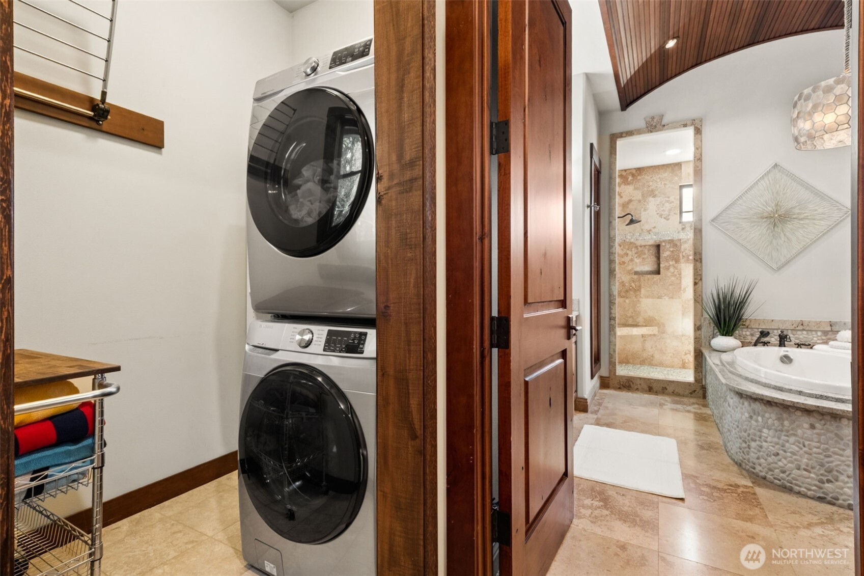 Enjoy the added convenience of an in-suite washer and dryer, complemented by a dedicated drying rack area—perfect for handling laundry with ease right within the primary retreat