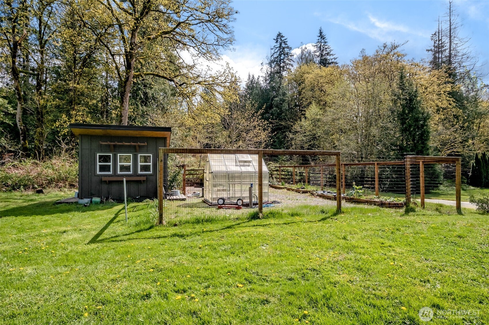 A spacious, fully fenced garden area offers a true outdoor retreat, complete with a greenhouse and charming garden shed—perfect for year-round growing, hobbies, or simply enjoying the natural surroundings. (With plenty of space to enlarge the garden!)