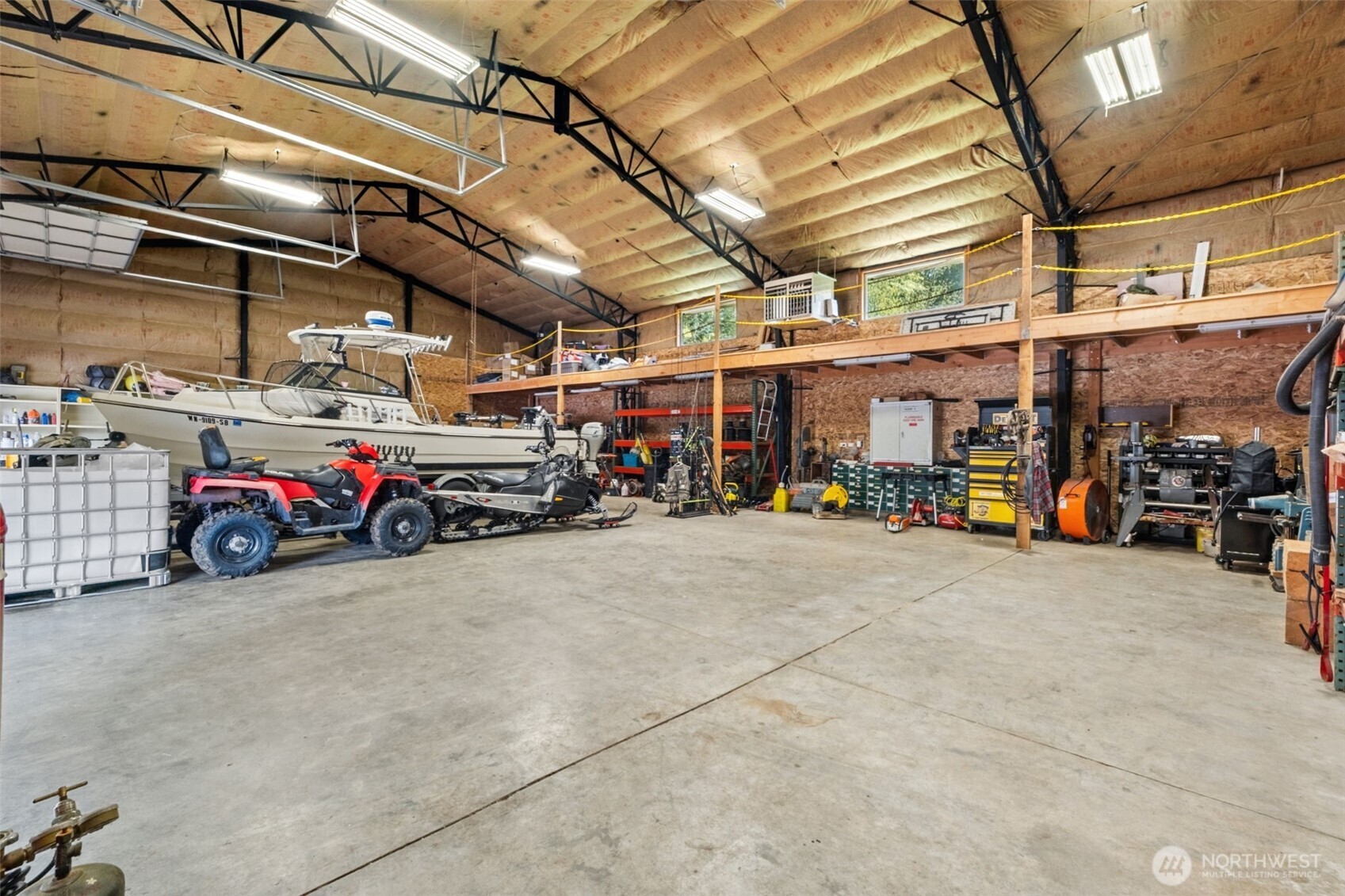 The steel-framed shop is built for versatility, with four separate overhead doors for easy access, (3 of which are 12’ x 16’) generous clear-span space, and an upper mezzanine providing valuable additional storage—perfect for vehicles, boats, or workshop needs.