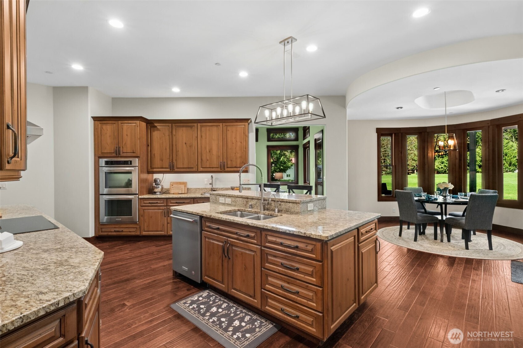 Perfect for daily living, the kitchen connects effortlessly to a bright, window-wrapped dining nook—bringing in natural light and peaceful views while keeping everyone close to the heart of the home.
