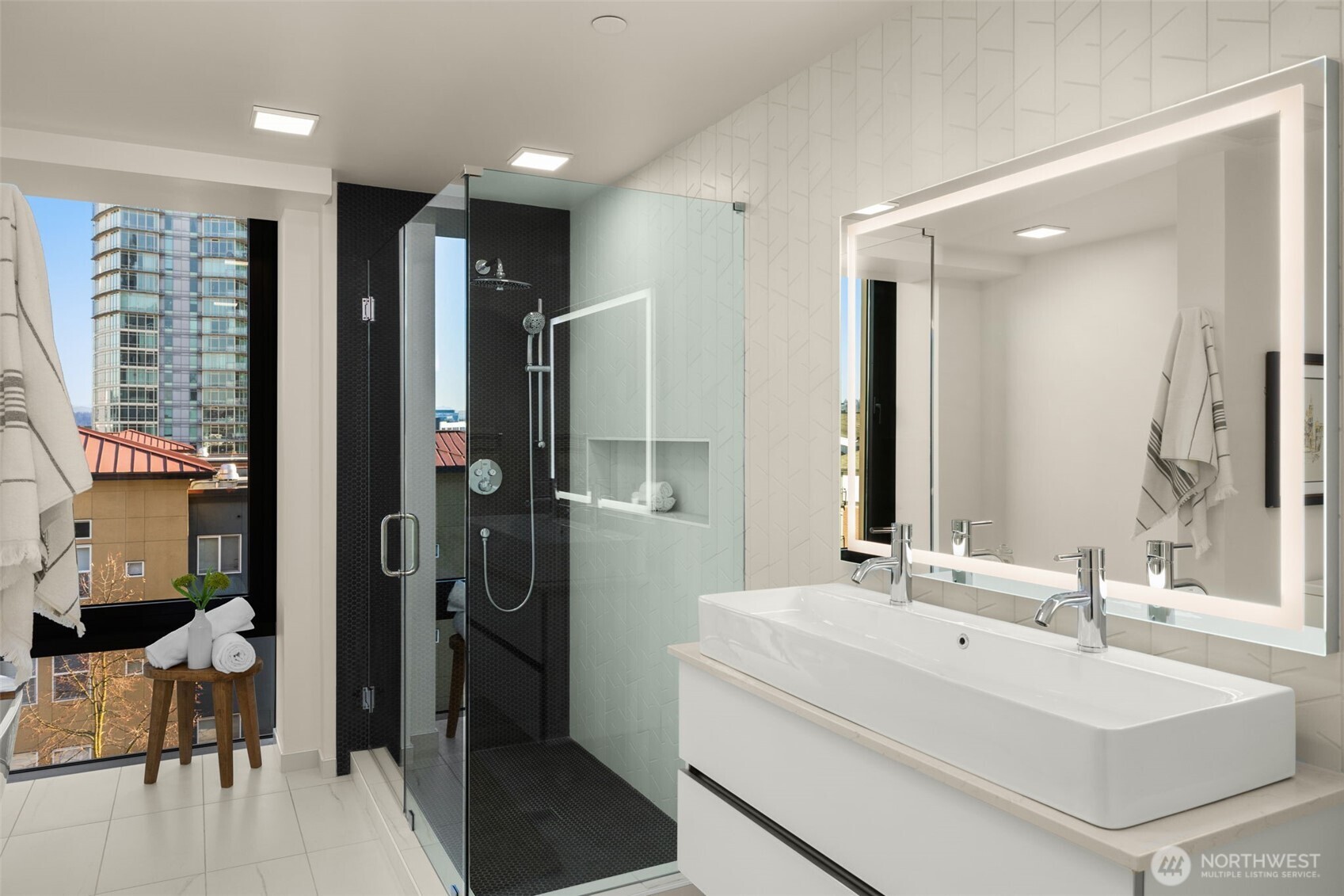 Luxurious Primary ensuite with heated floors, walk-in ceramic shower and a soaking tub with views.