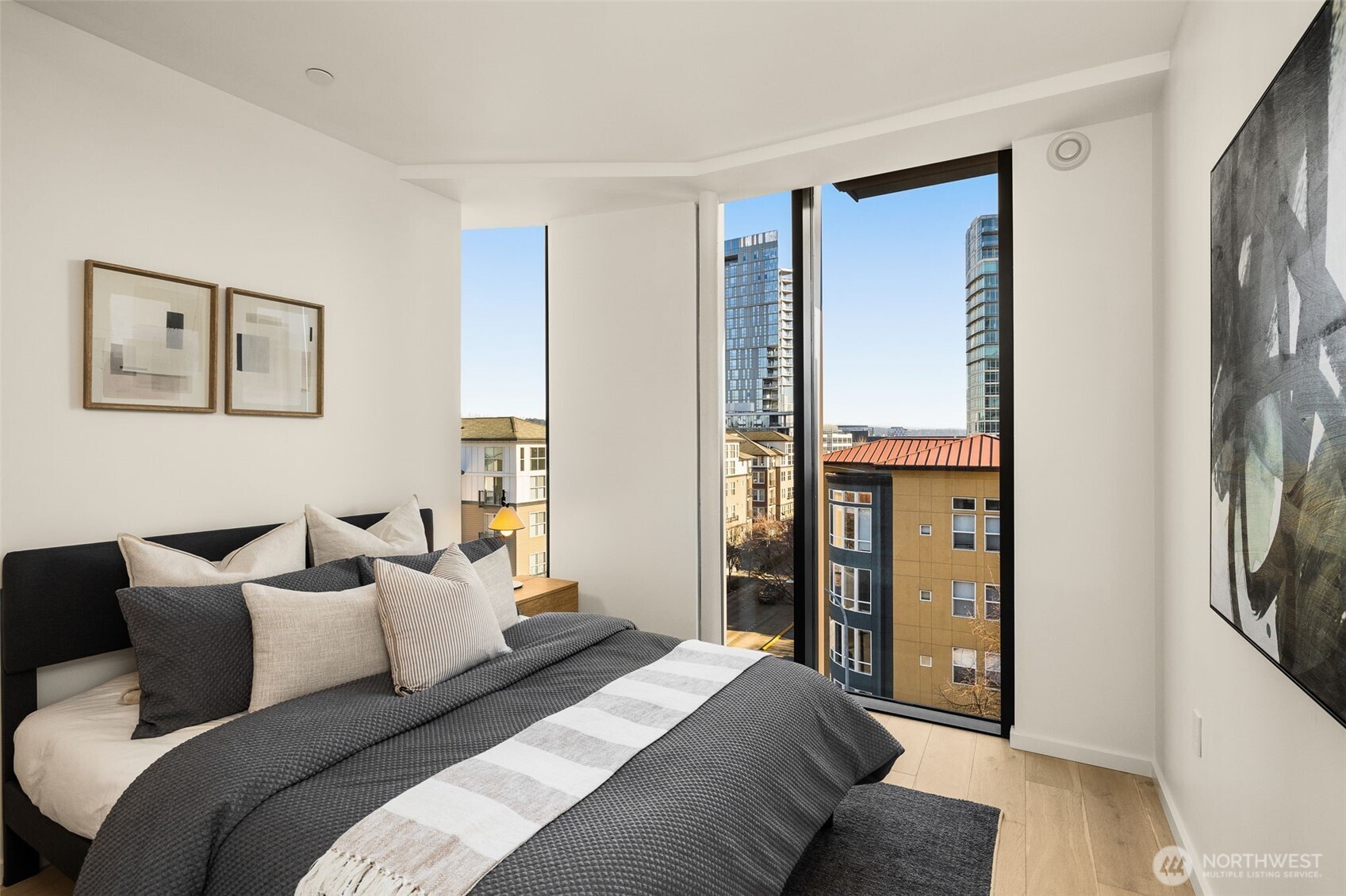 Secondary bedroom features floor-to-ceiling windows, engineered hard woods and a minisplit for heating and cooling.