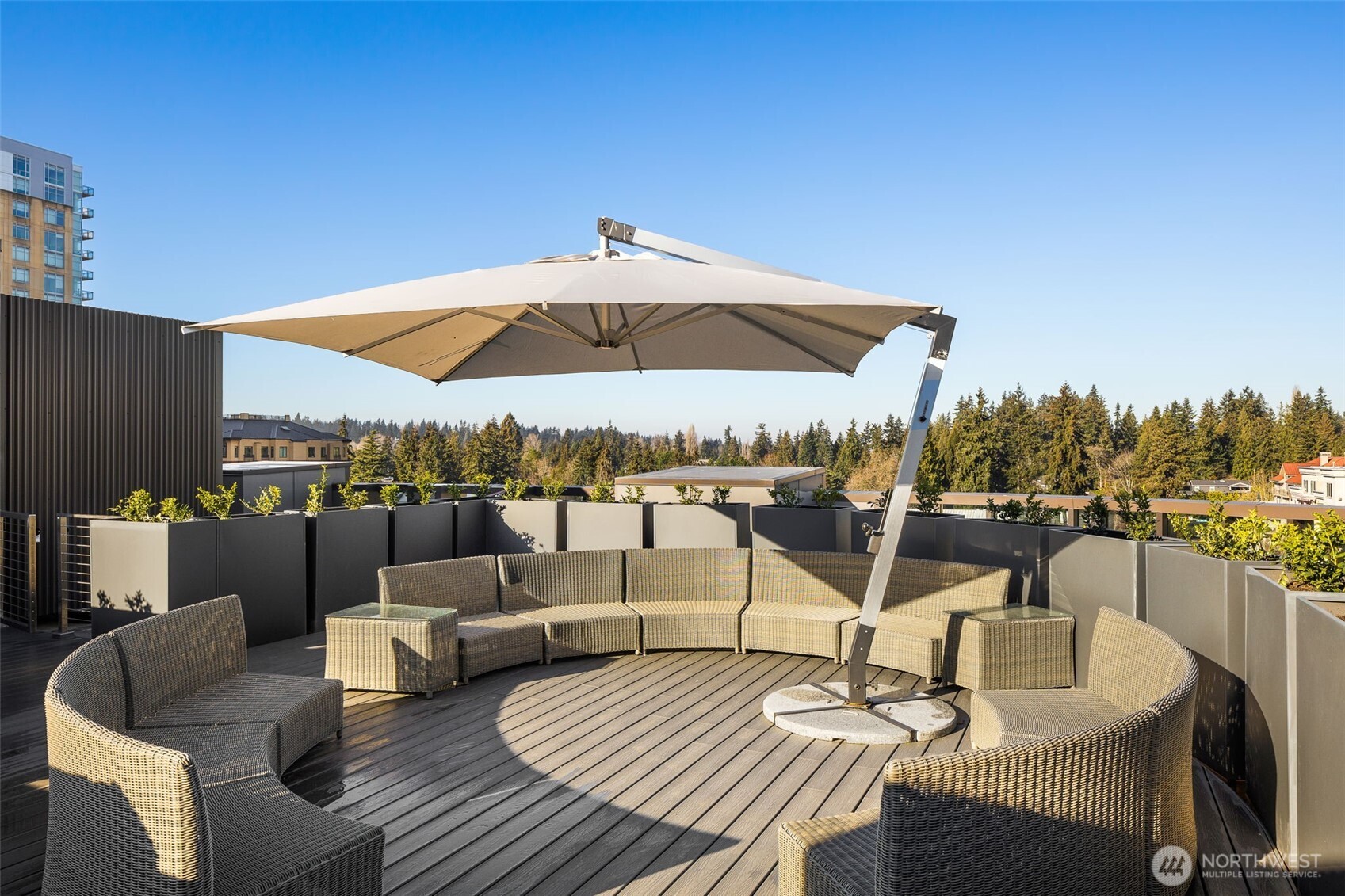 Rooftop deck with panoramic views of the city and mountains.