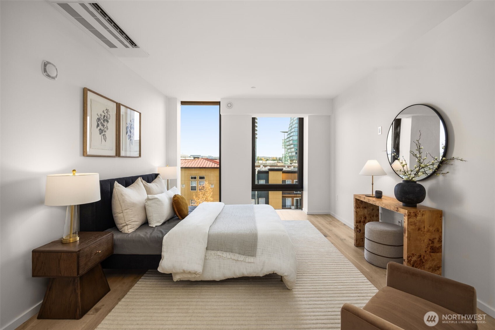 Primary bedroom features floor to ceiling