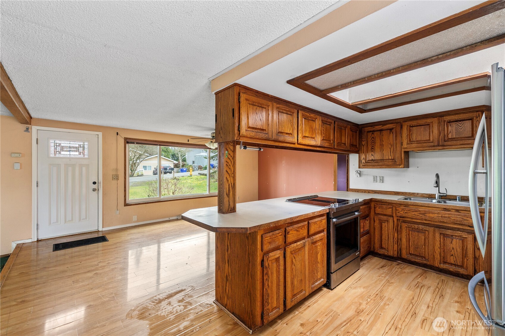 Open concept kitchen, dining and living area with french doors to the back deck.