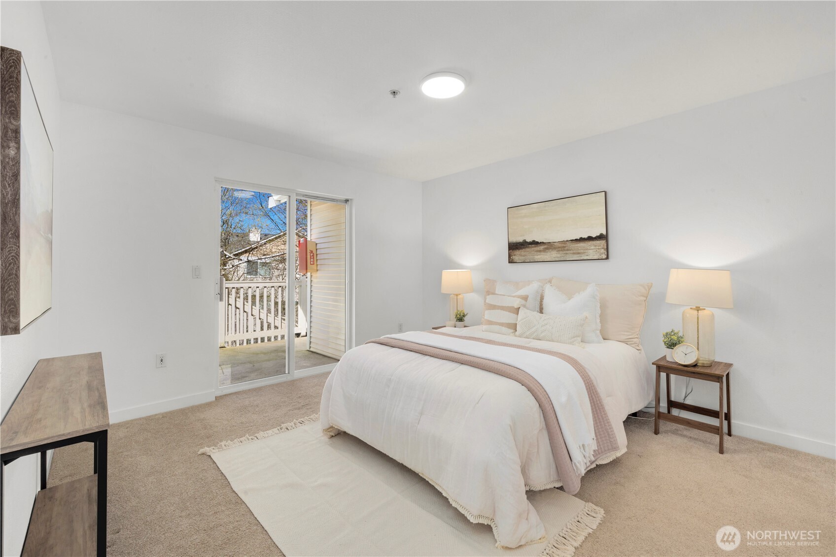 Peaceful primary suite with slider out to patio