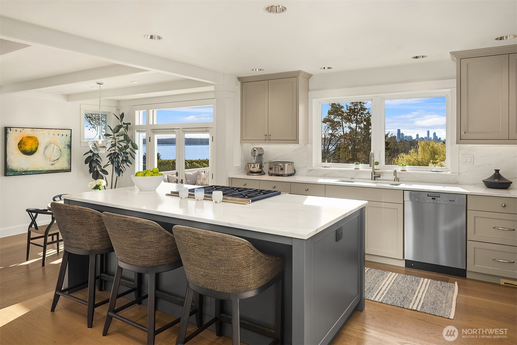 This kitchen was fully redone in late 2020- brand new custom cabinets, refrigerator drawers, beautiful slab marble and wide plank white oak floors.