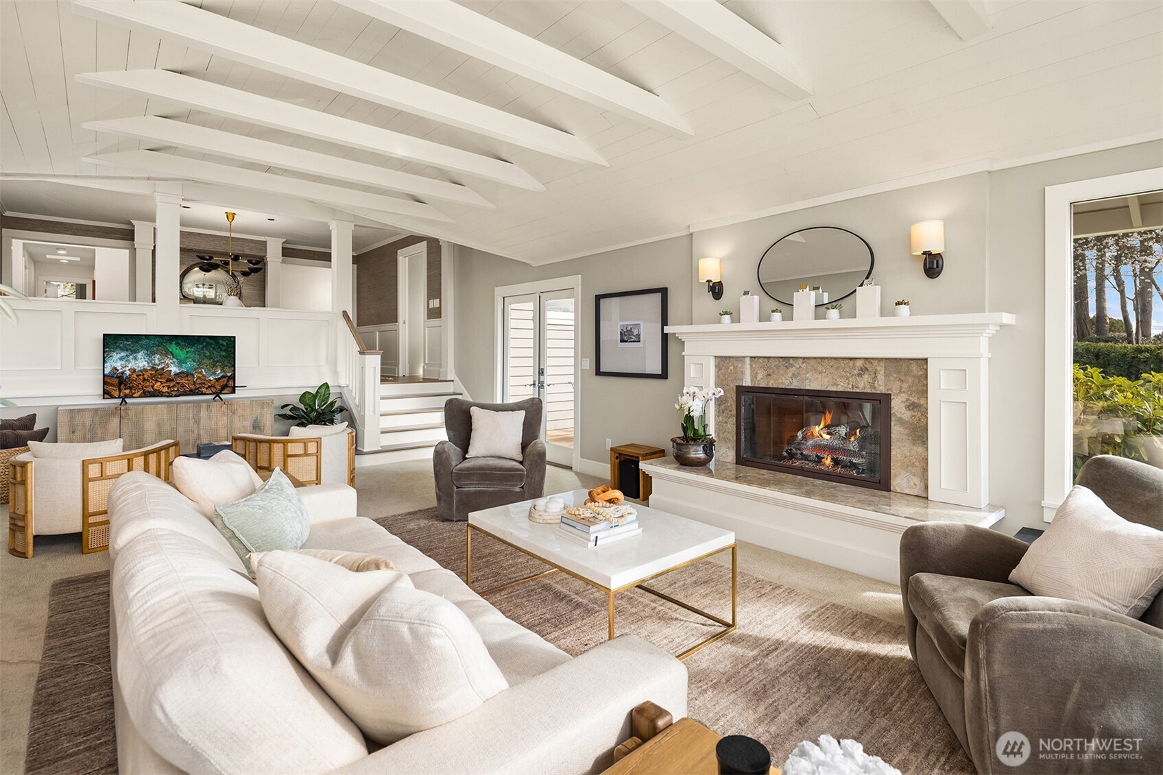 This isn't your mother's living room.  it is a fabulous flex entertaining space.  It connects out to a great outdoor deck allowing for seamless connection to indoor outdoor entertaining.  Great for a crowd to watch your favorite movies or games and enjoy the view too!