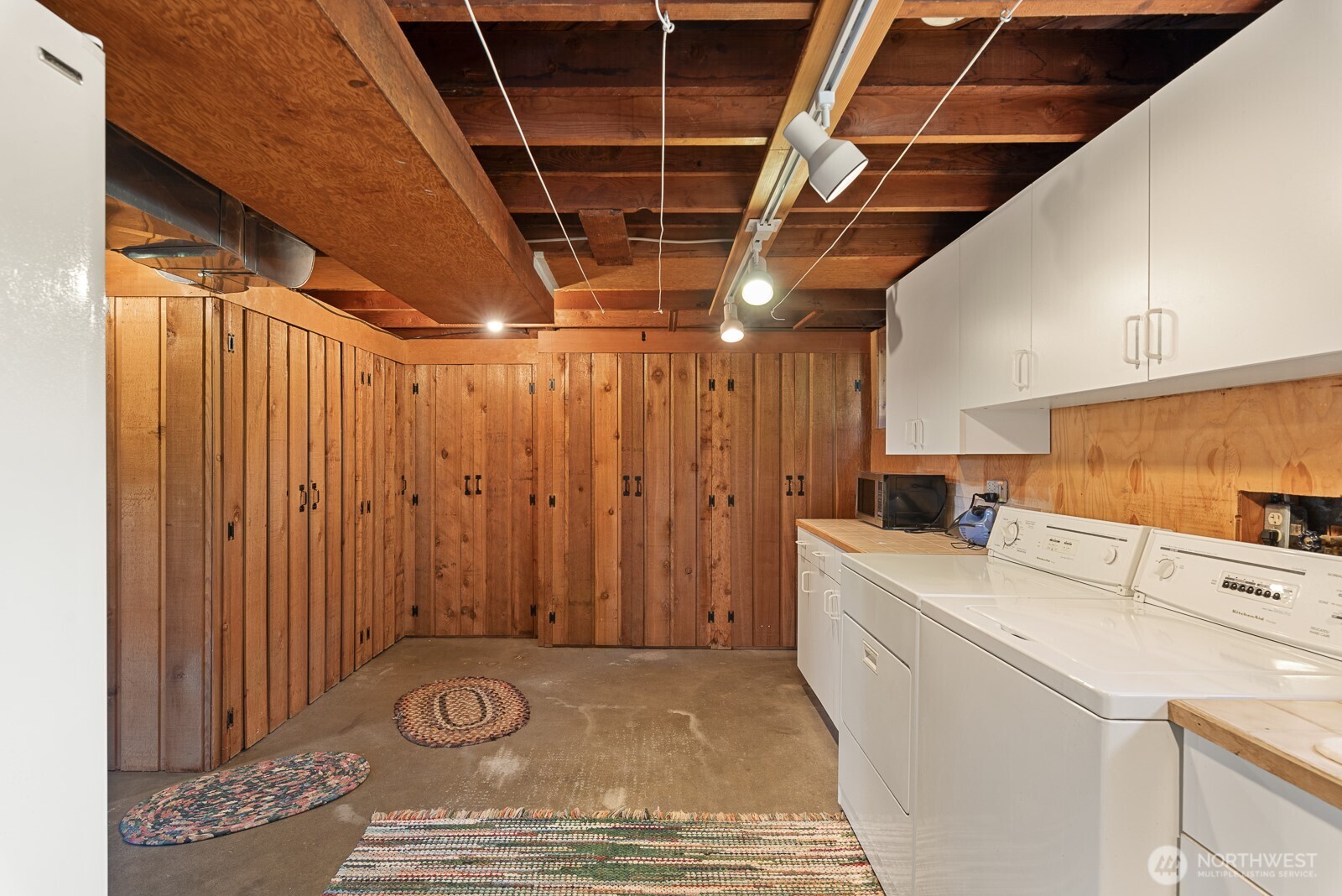 Basement with tons of built in storage and laundry area with folding counter