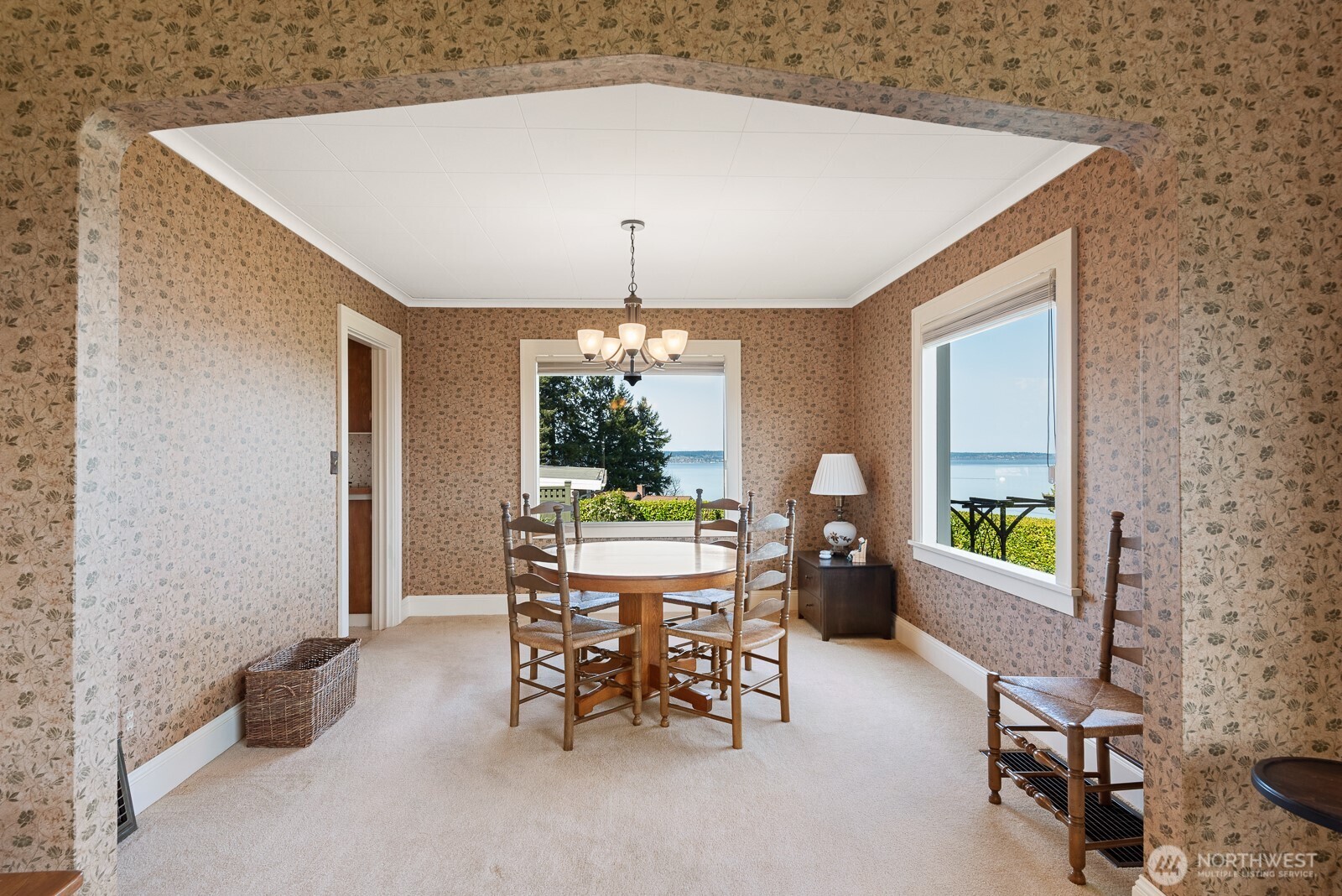 Living room open to dining room with charming arch