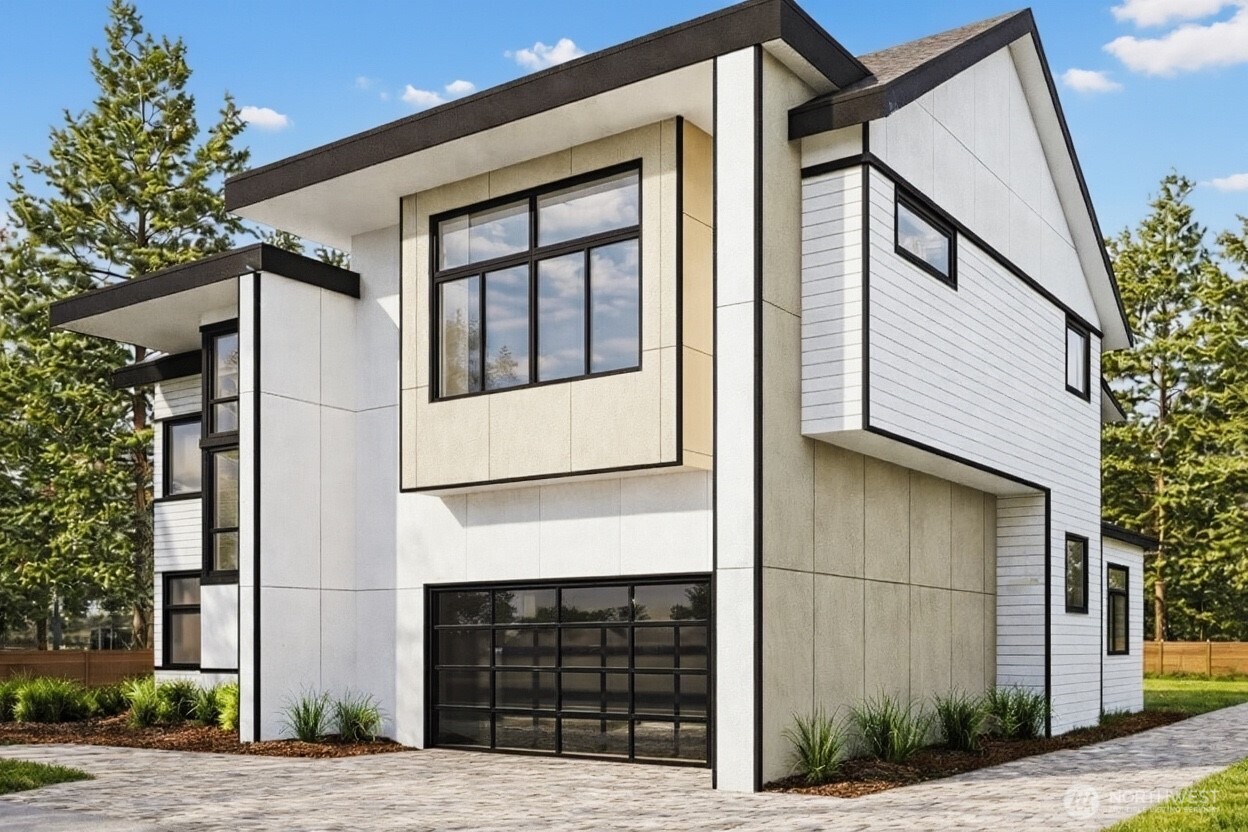 Paver driveway to modern 2 car garage. Parking pad on the right of home leads to the DADU. Photo is a rendering.