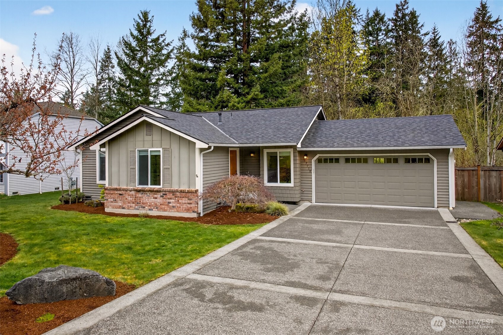 Set against a crisp Pacific Northwest sky, the classic board-and-batten and brick accent facade delivers timeless curb appeal on a quiet English Hill cul-de-sac. The generous front lawn and mature landscaping create a welcoming first impression with minimal upkeep.