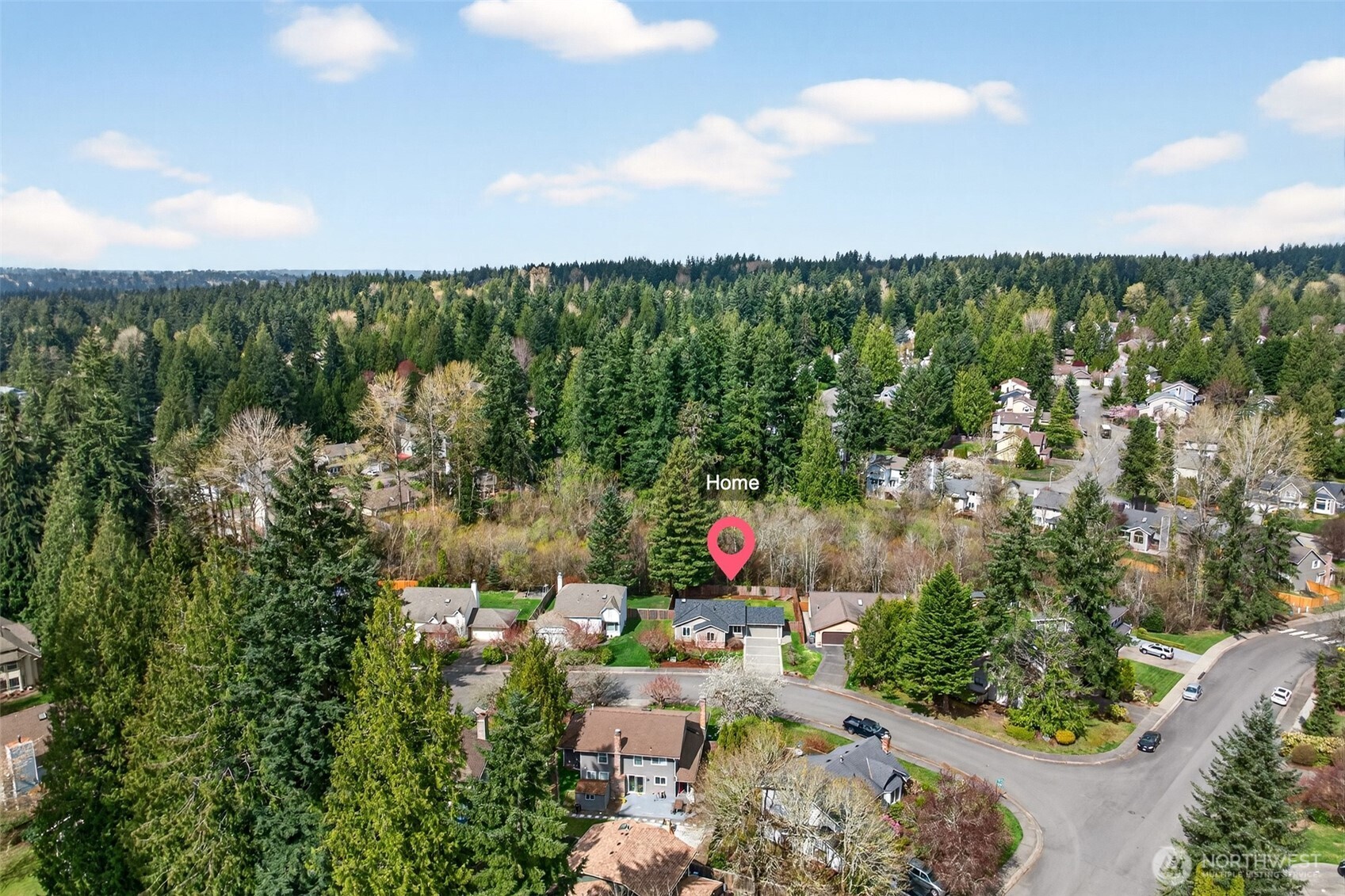 Nestled within the tree-canopied Glenterra neighborhood on English Hill, this home sits in one of Redmond's most naturally immersive residential settings — surrounded by mature evergreens and just minutes from the tech corridors of Microsoft, Google, and Amazon. The aerial perspective captures exactly what makes this location so compelling: the privacy and serenity of a wooded enclave with all the convenience of the Eastside just beyond.
