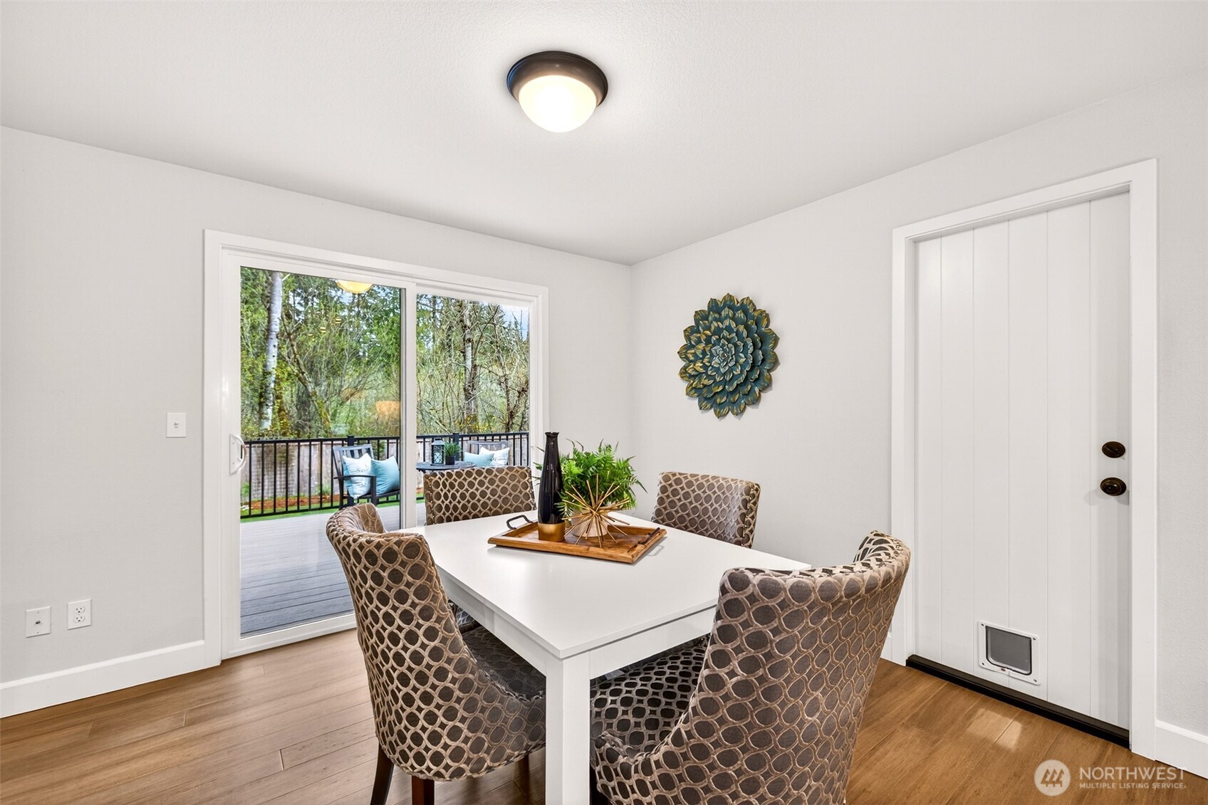 The dining area opens directly to the rear deck through sliding glass doors, creating a seamless indoor-outdoor flow that's perfect for morning coffee or al fresco dinners surrounded by greenbelt greenery. No rear neighbors and no HOA means you enjoy that private backdrop entirely on your own terms.