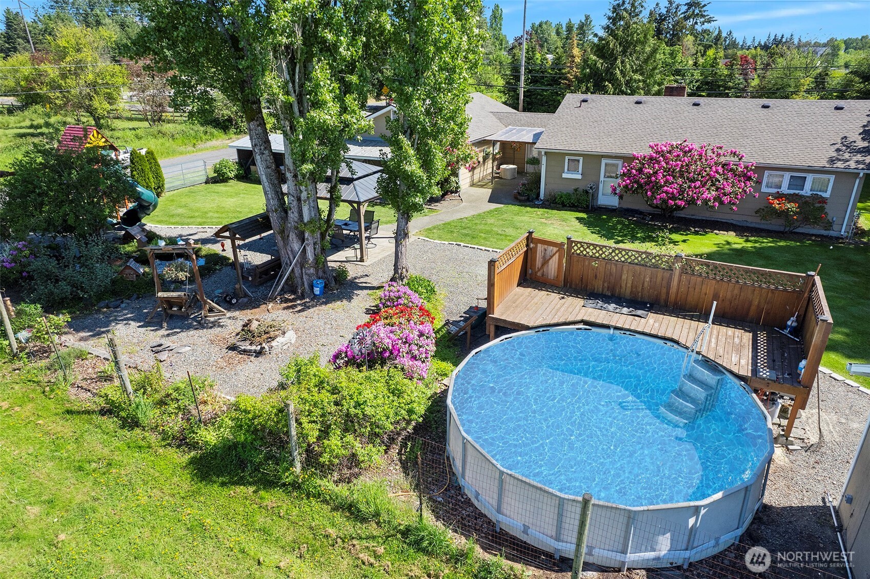 ~View of Pool & Fire Pit surrounded by flowers galore~