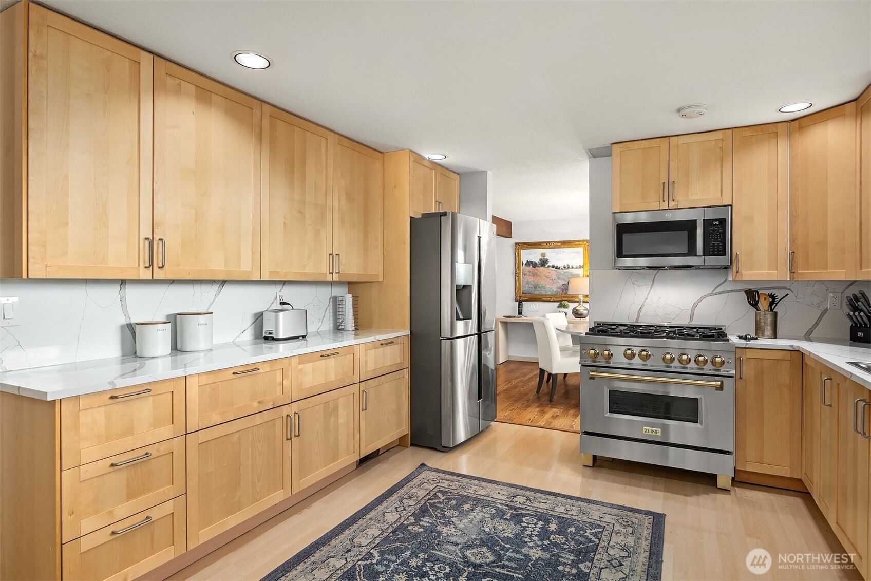An abundance of cabinetry, plus lovely quartz countertops and backsplash for meal prep and staging.