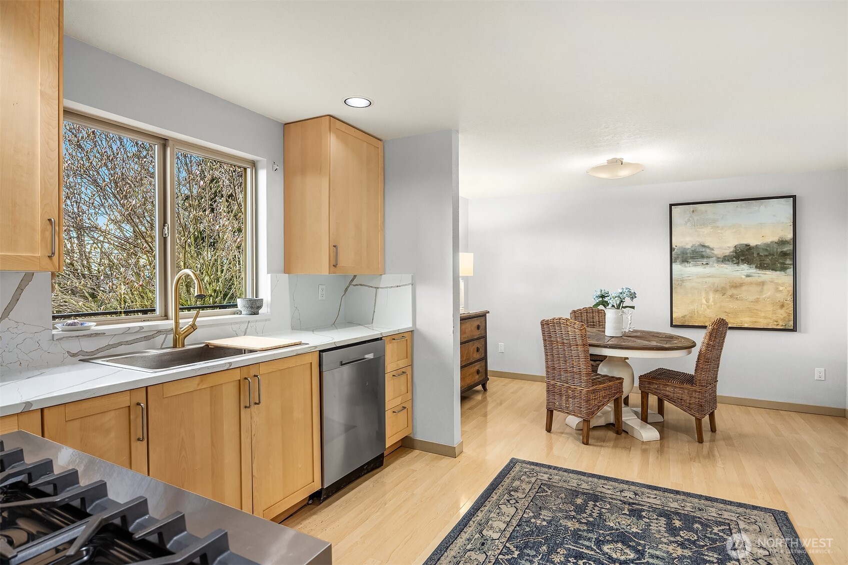The oversized sink and brushed gold faucet overlook the deck and views.