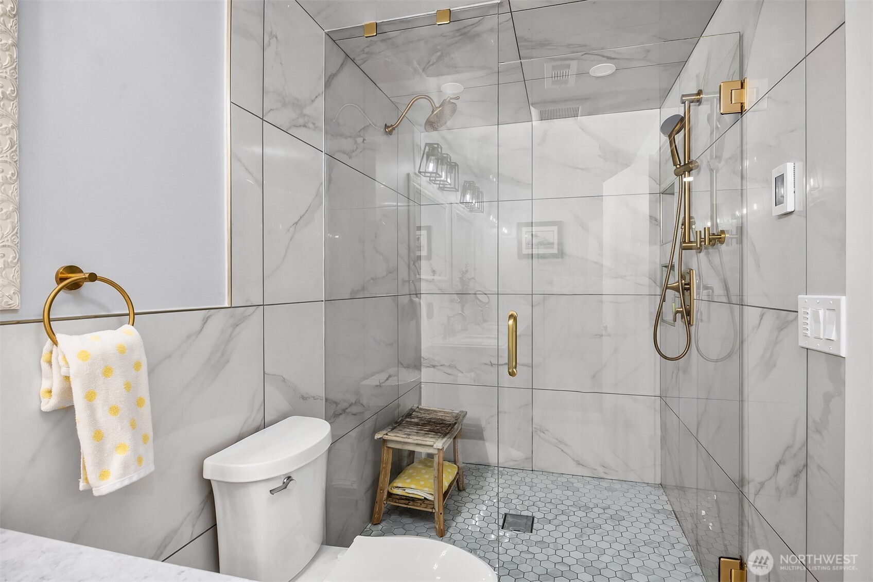 The beautiful double shower with seamless glass door. and brushed gold hardware.